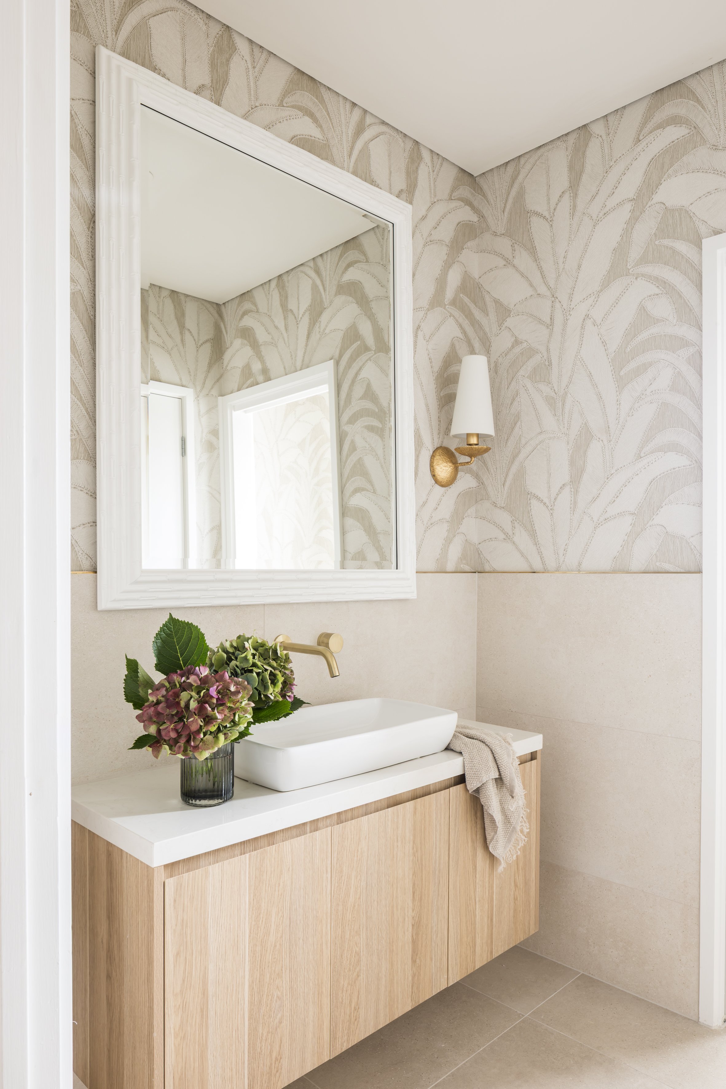 Wallpapered powder room with timber vanity and brass tapware, Shell Cove