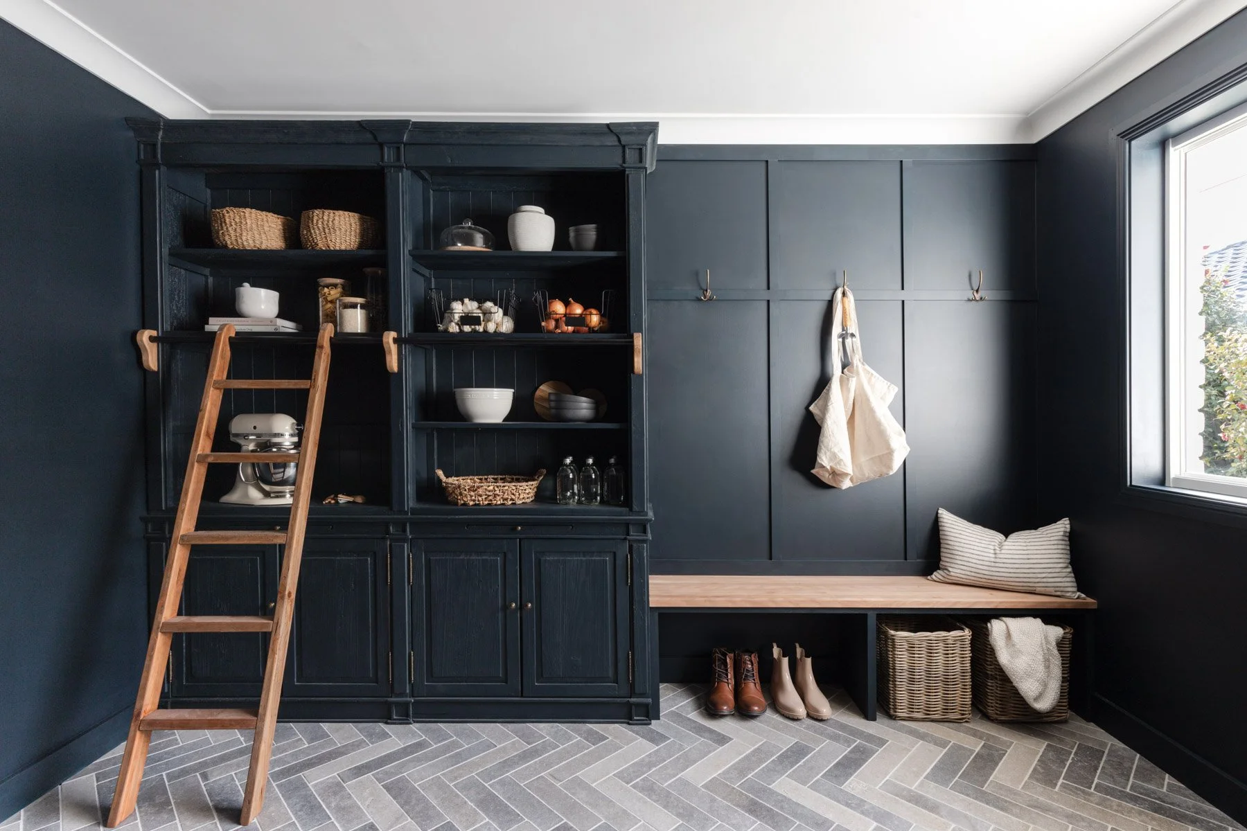 Navy panelled mud room with library ladder and herringbone floor, Bowral
