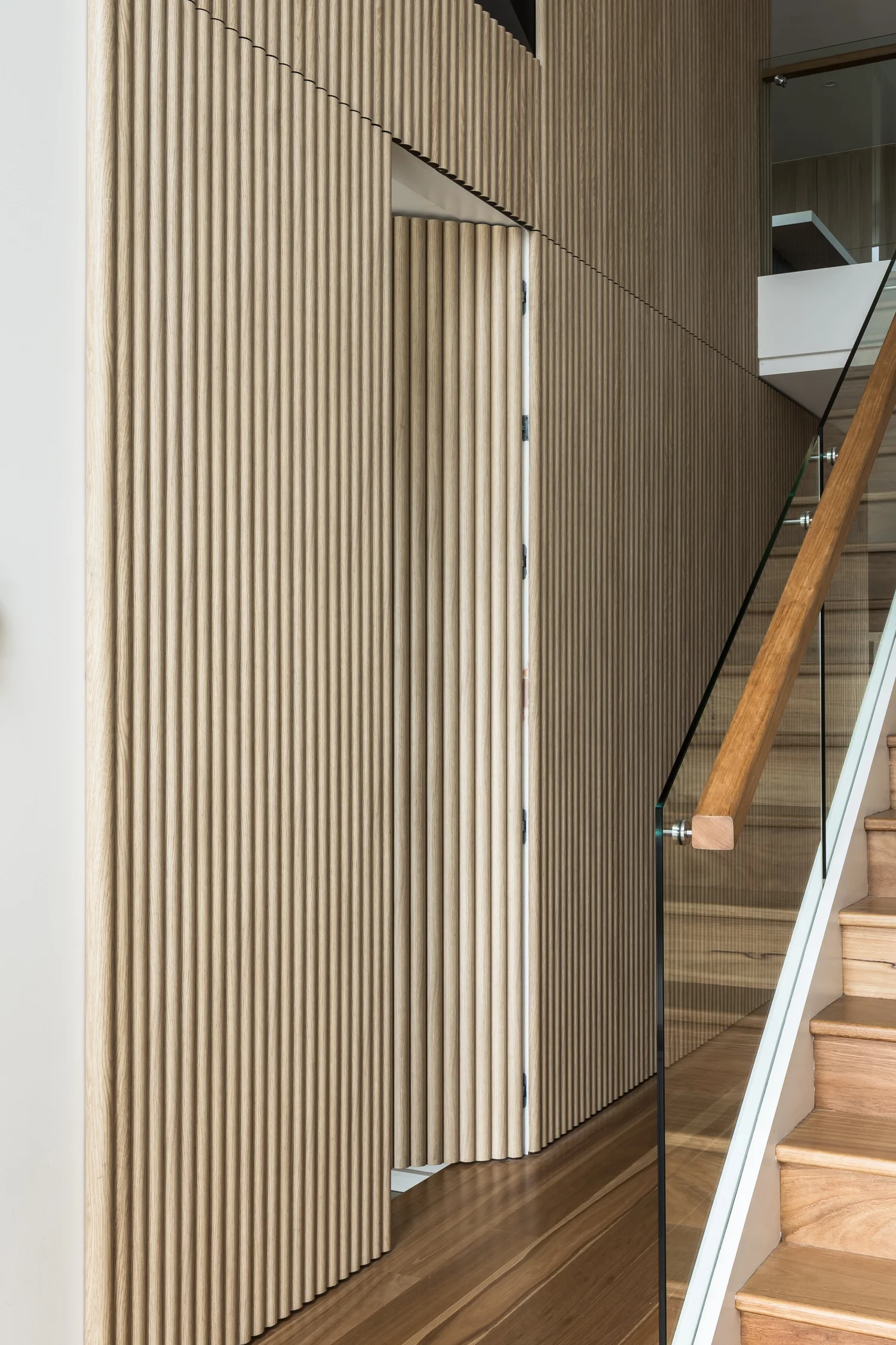 Custom hidden door joinery by Oakmont Building Group
