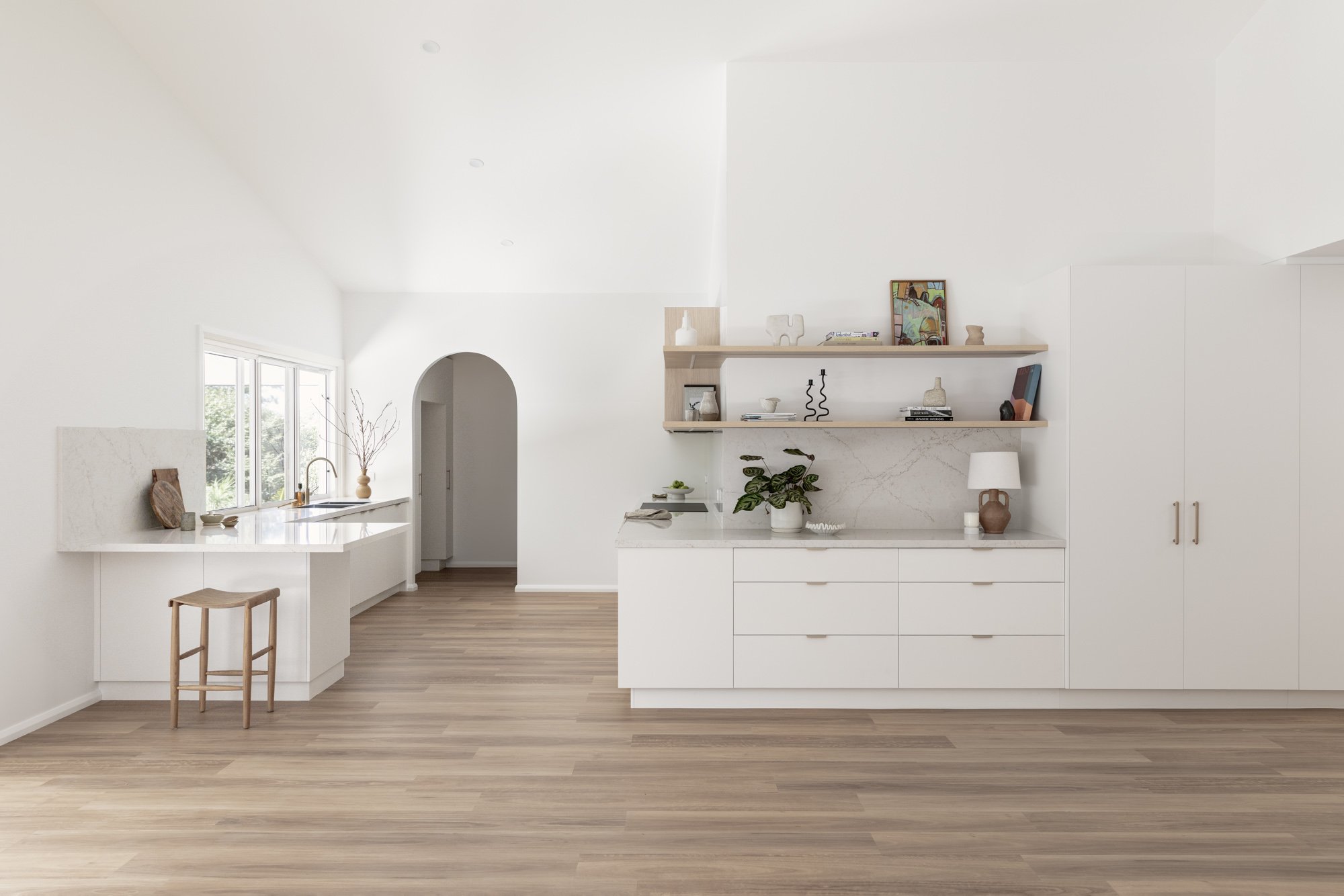 Open plan kitchen beneath a vaulted ceiling with arched doorway, Corrimal extension