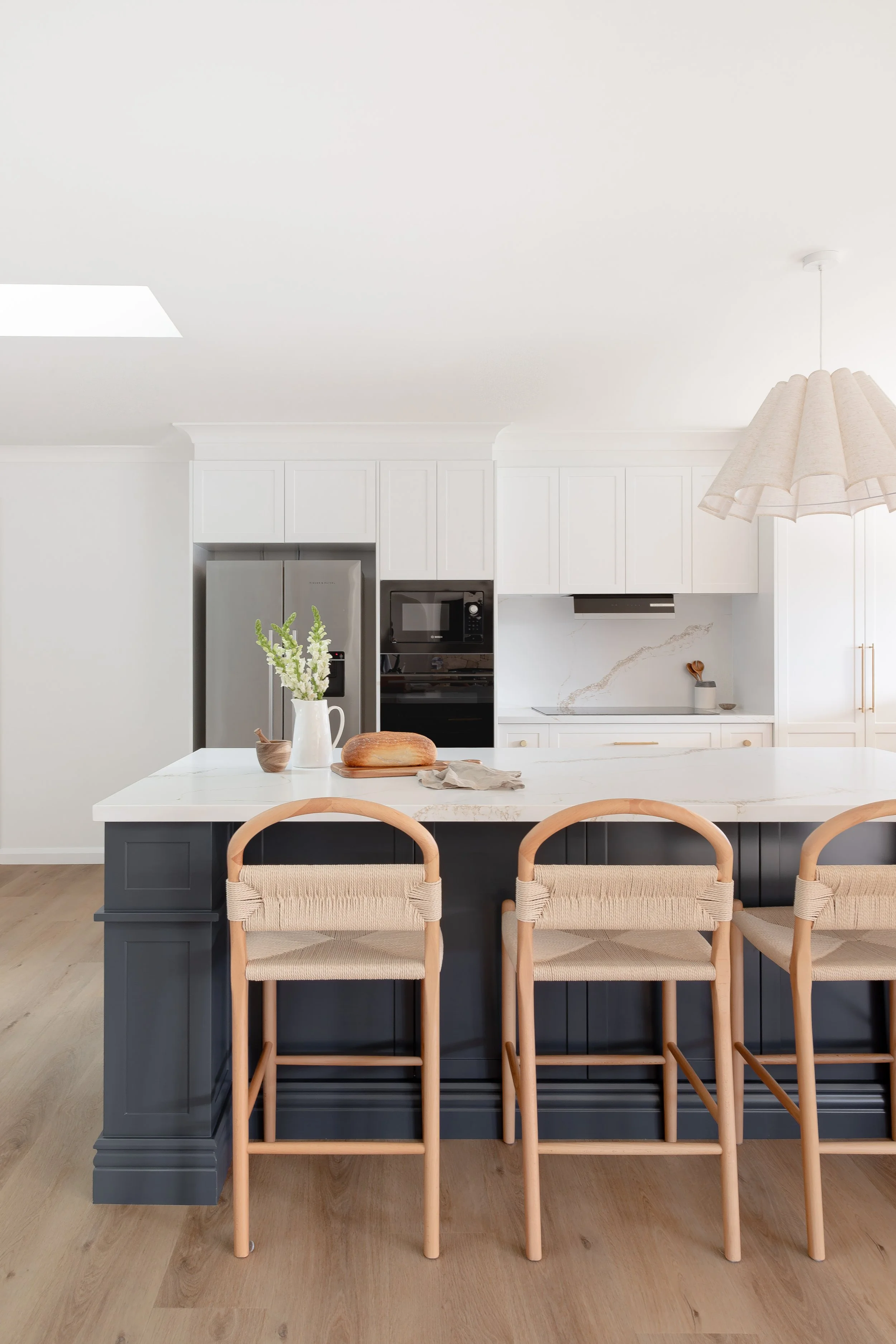 Navy shaker kitchen island with brass handles and stone benchtop, Albion Park home renovation