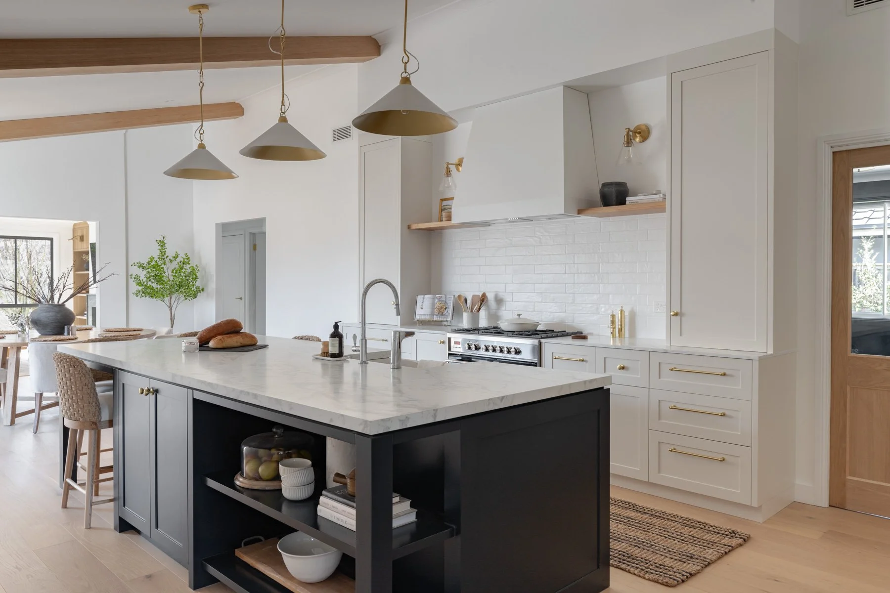 Navy kitchen island with brass pendants beneath Victorian ash beams, Bowral country home renovation