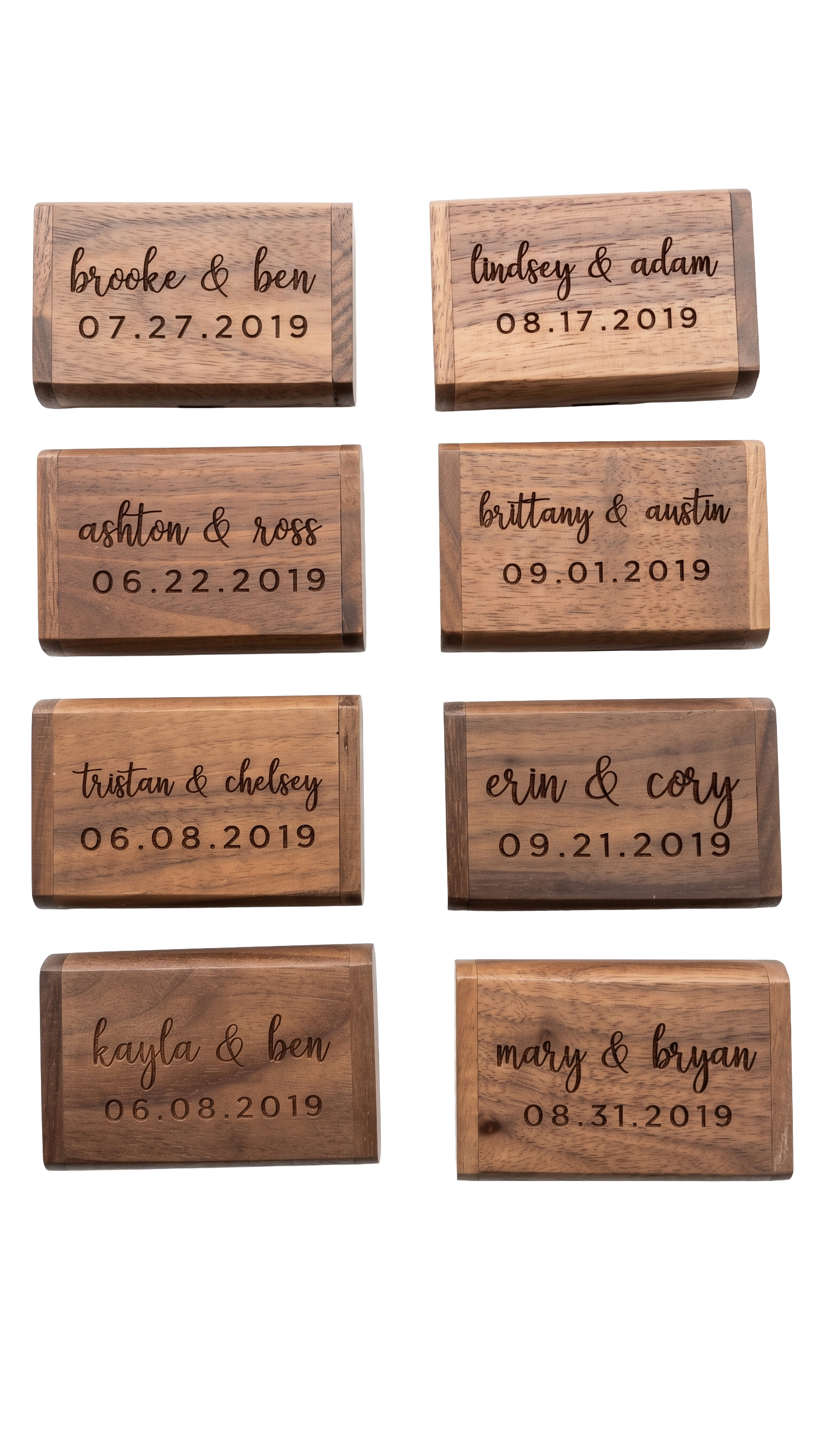 Wooden block plaques engraved with names and dates, likely for a wedding or event. The plaques display paired names with dates below, such as 'brooke & ben 07.27.2019' and 'lindsey & adam 08.17.2019', arranged in two columns.