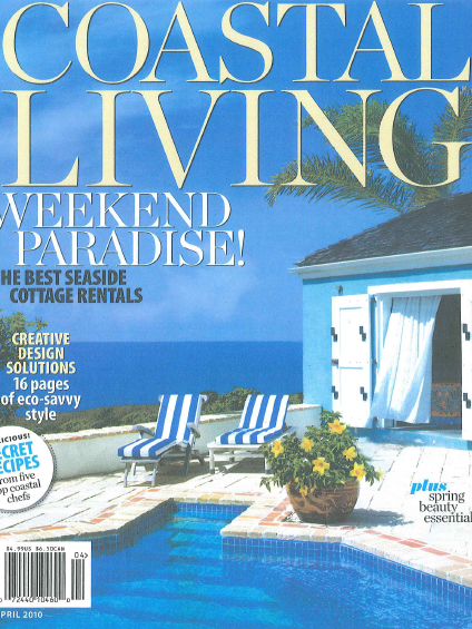 Magazine cover titled 'Coastal Living' featuring a poolside scene with two striped lounge chairs, a potted plant, a small pool, and a cottage with an open door, set against a background of the ocean and clear blue sky.