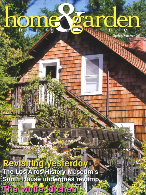 The cover of Home & Garden magazine, Spring/Summer 2011 edition, featuring a wooden house with shingled exterior, white window frames, and surrounding greenery.