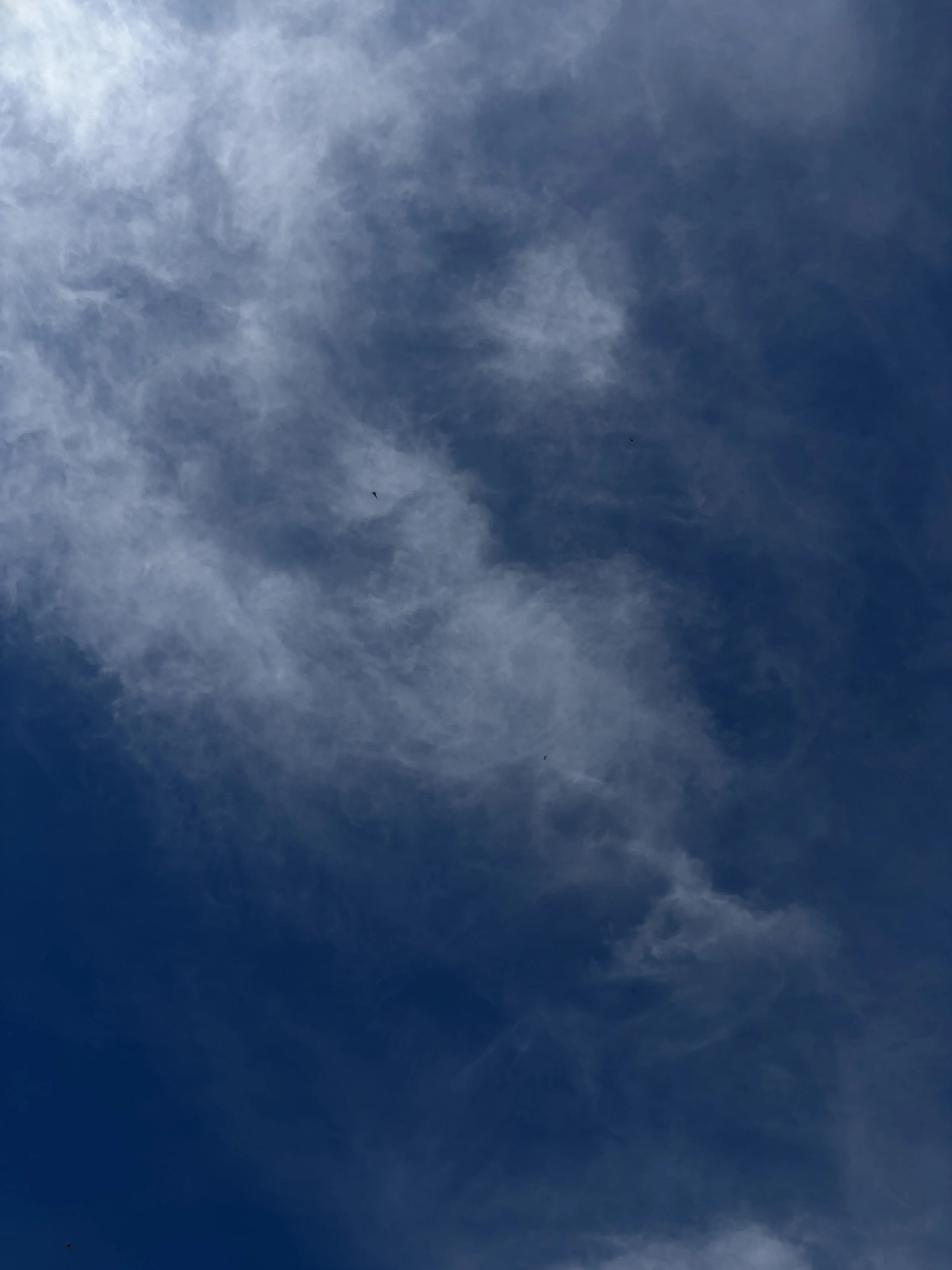 Blue sky with scattered white clouds.