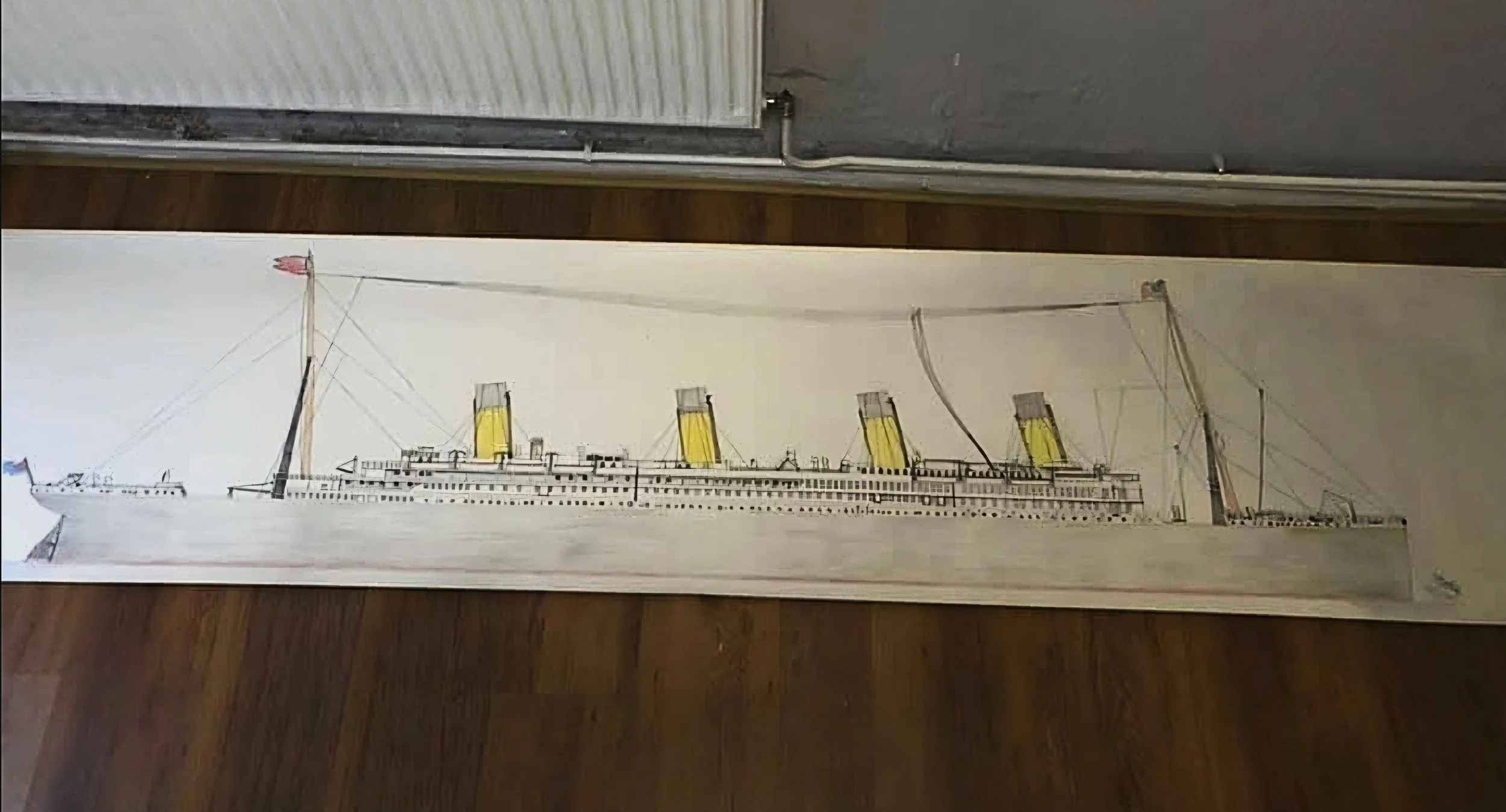 A drawing of the Titanic ship with yellow funnels and multiple decks, depicted on a long, horizontal canvas.