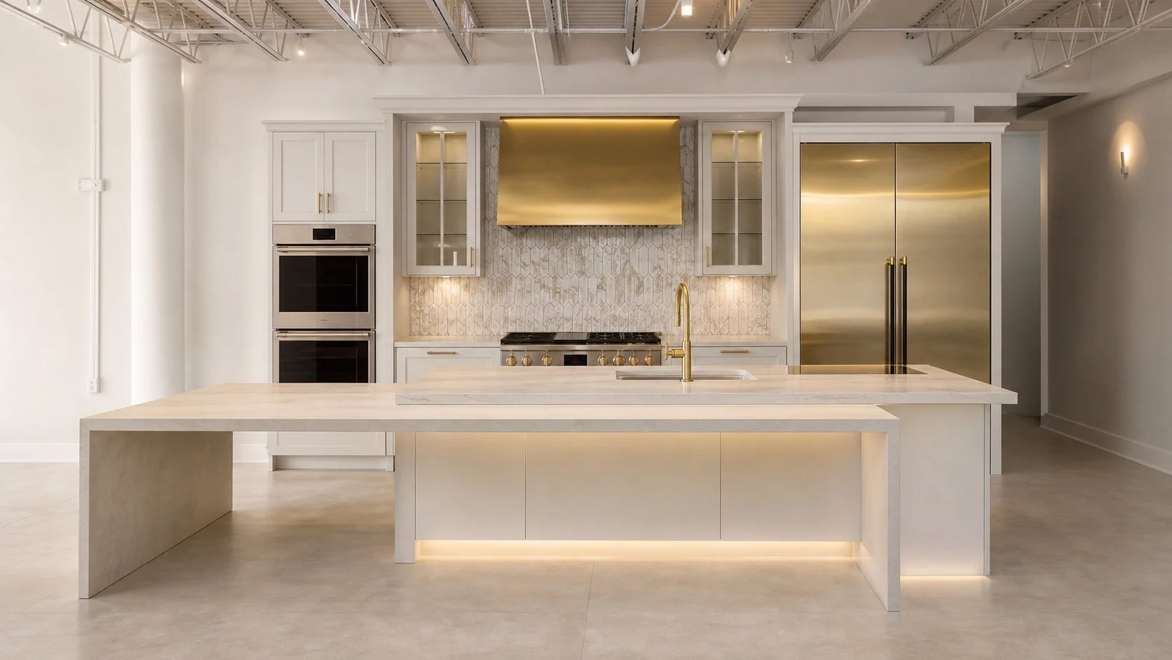 Monogram kitchen display at The Luxury Tree House showroom, with white cabinetry and a large island.