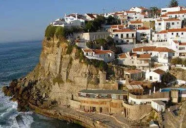 Whitewashed seaside village built on a dramatic rocky cliff above the Atlantic Ocean