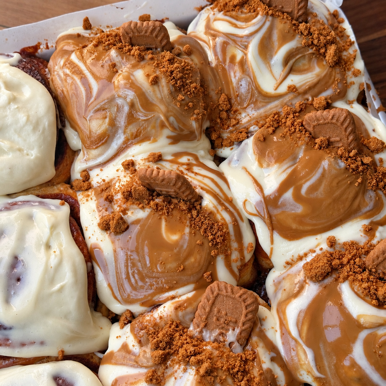 Frosted cinnamon rolls with Biscoff crumbs.png