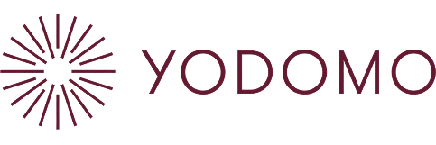 Yodomo logo with a stylized circular graphic resembling fireworks or a burst next to the word "Yodomo" in purple letters.