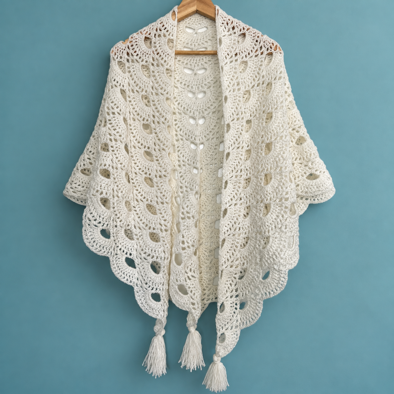 Ivory Crochet Shawl on Wooden Hanger.png