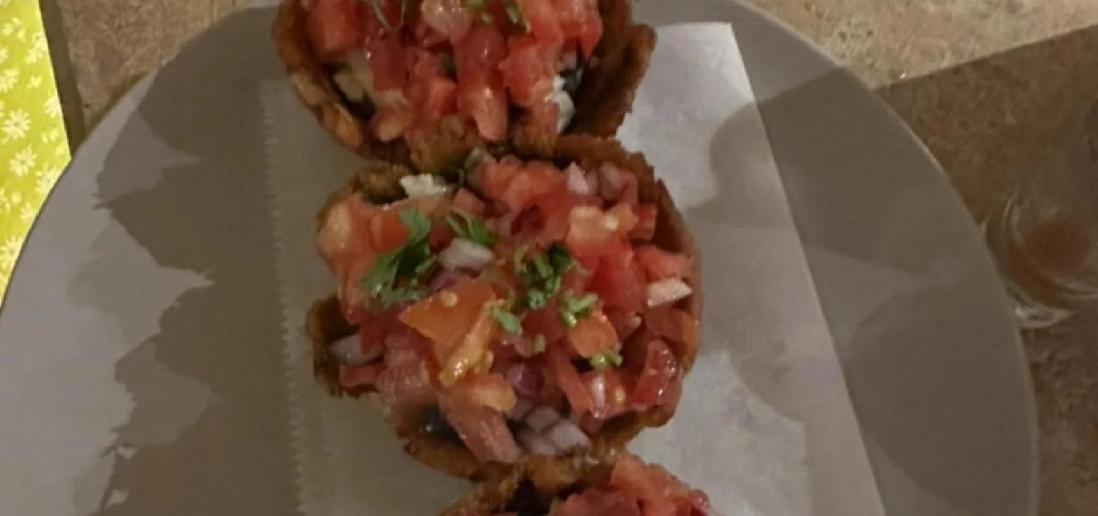 Patacones topped with black beans and pico de gallo at a restaurant in Guanacaste, Costa Rica