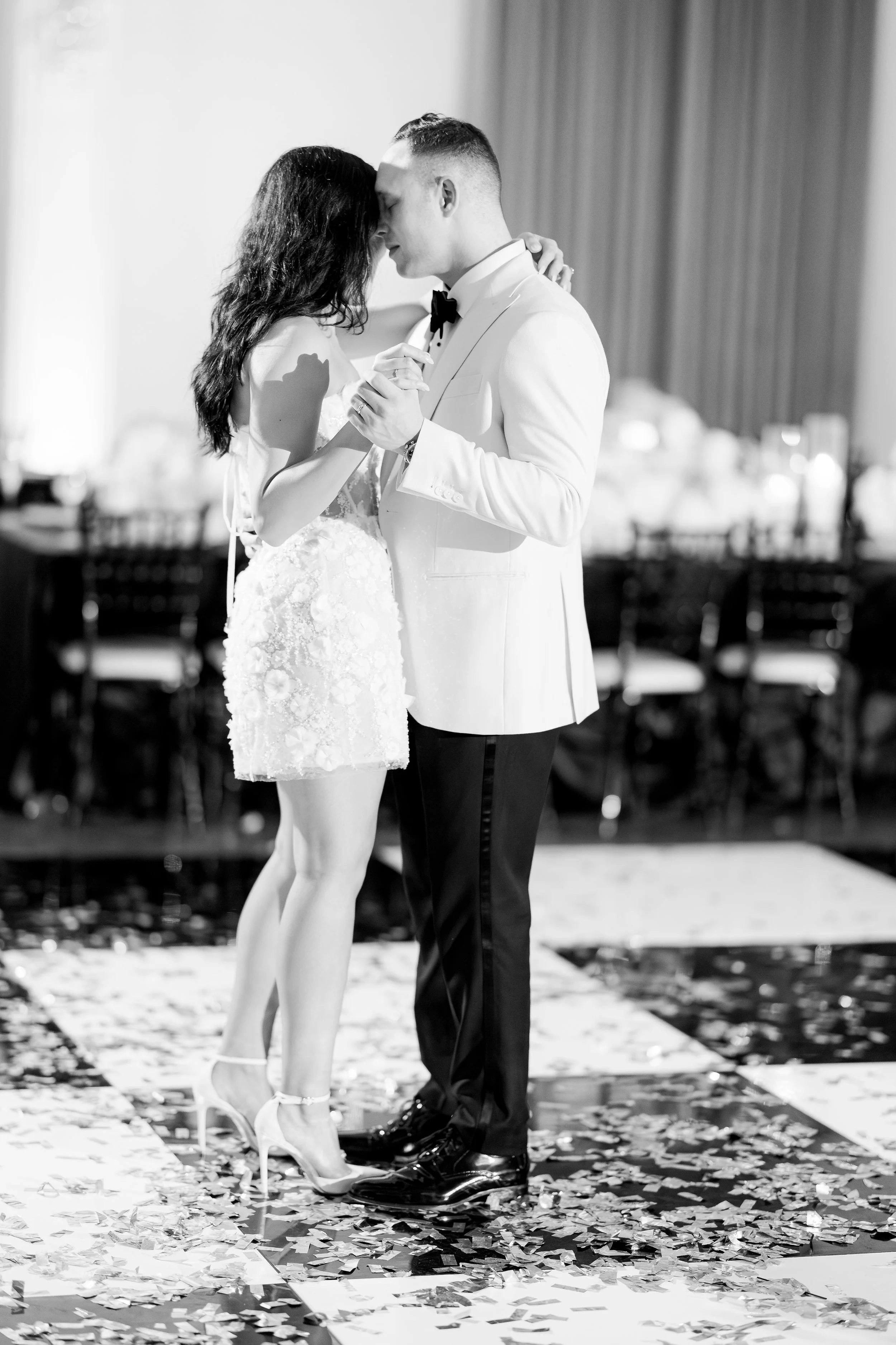 Black-and-white photograph of a couple practicing their wedding dance together
