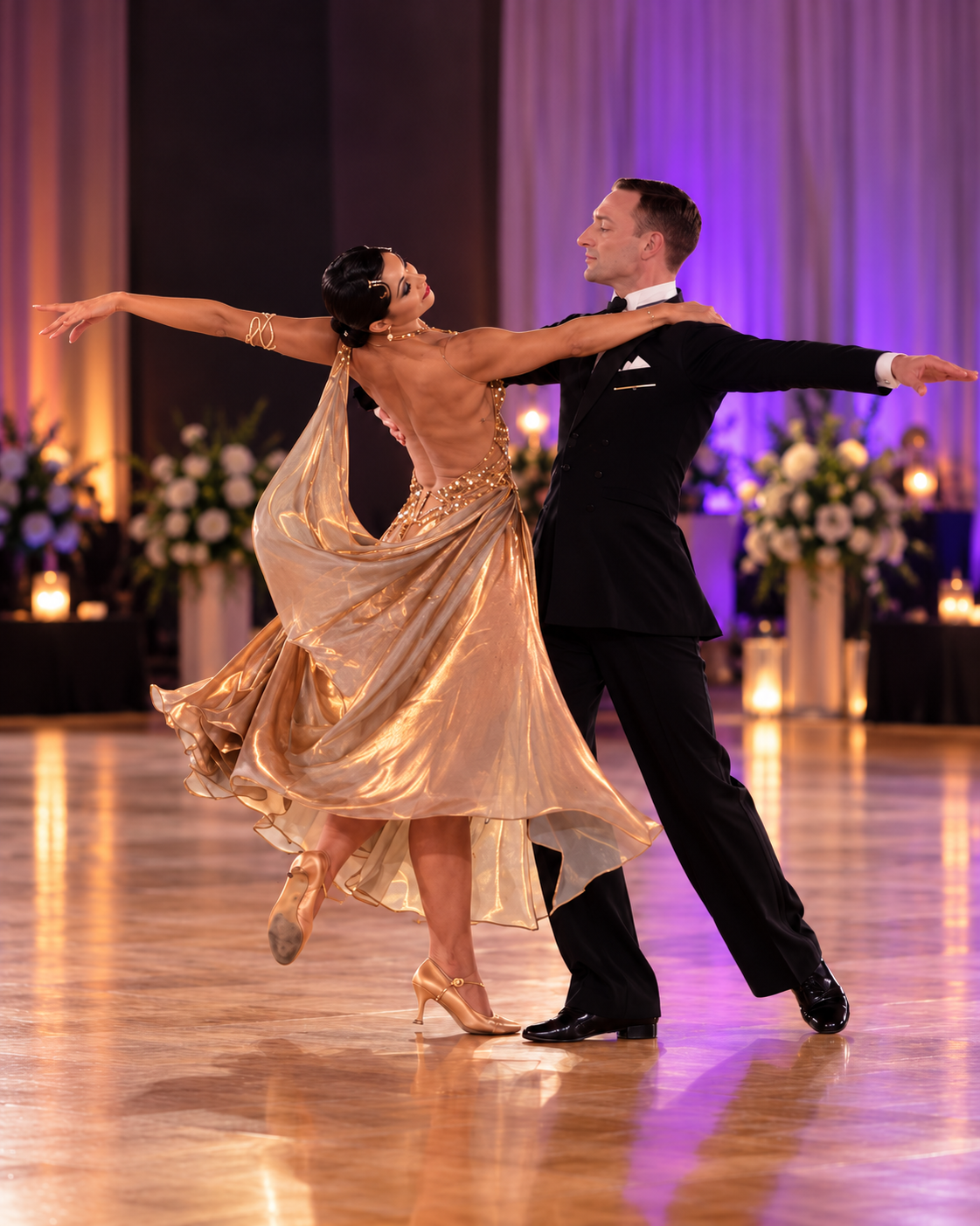 Ballroom dancers performing an extended pose in competition attire