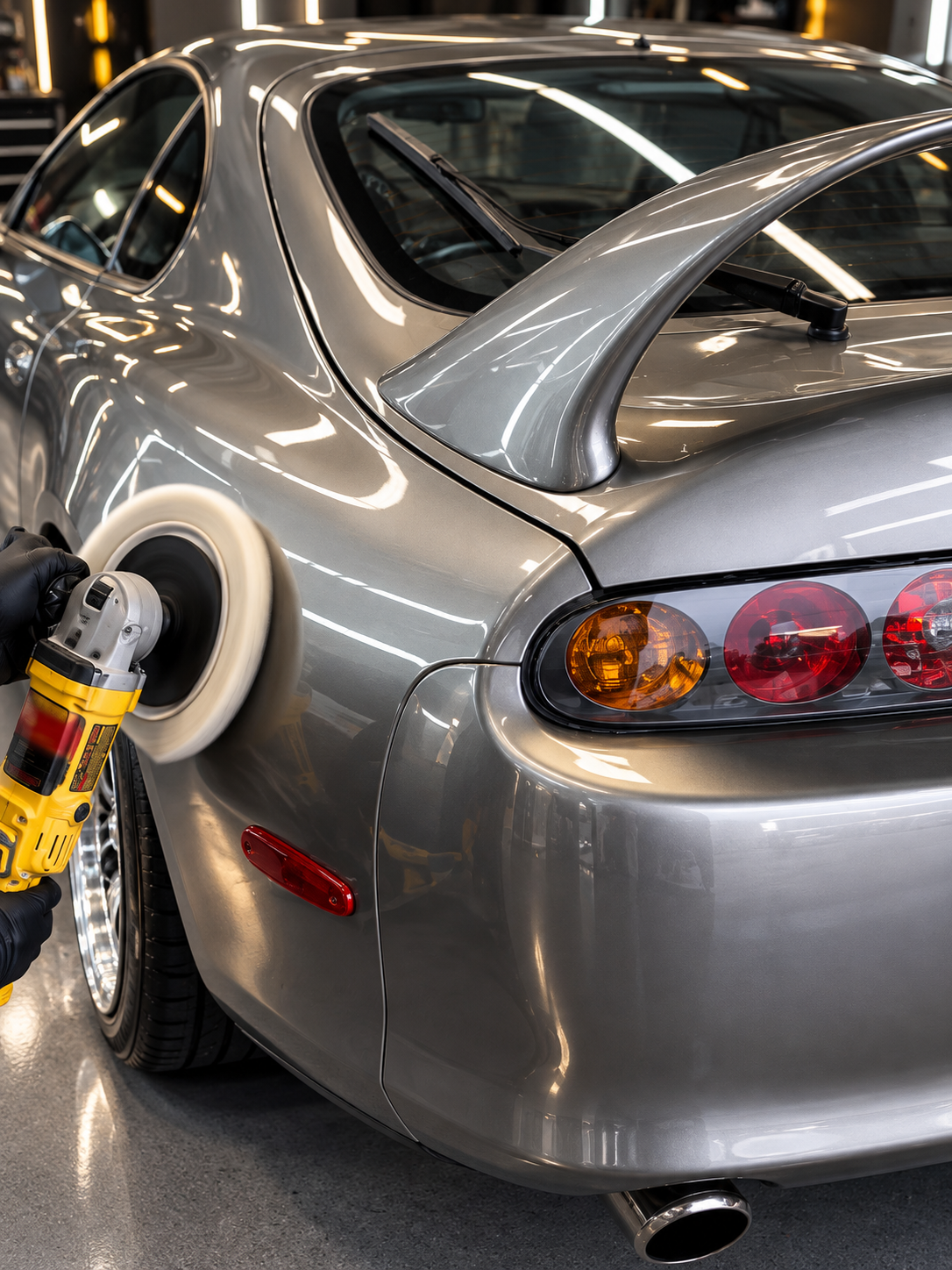 Machine polishing a silver Toyota Supra at Detail Link in Rockville, MD