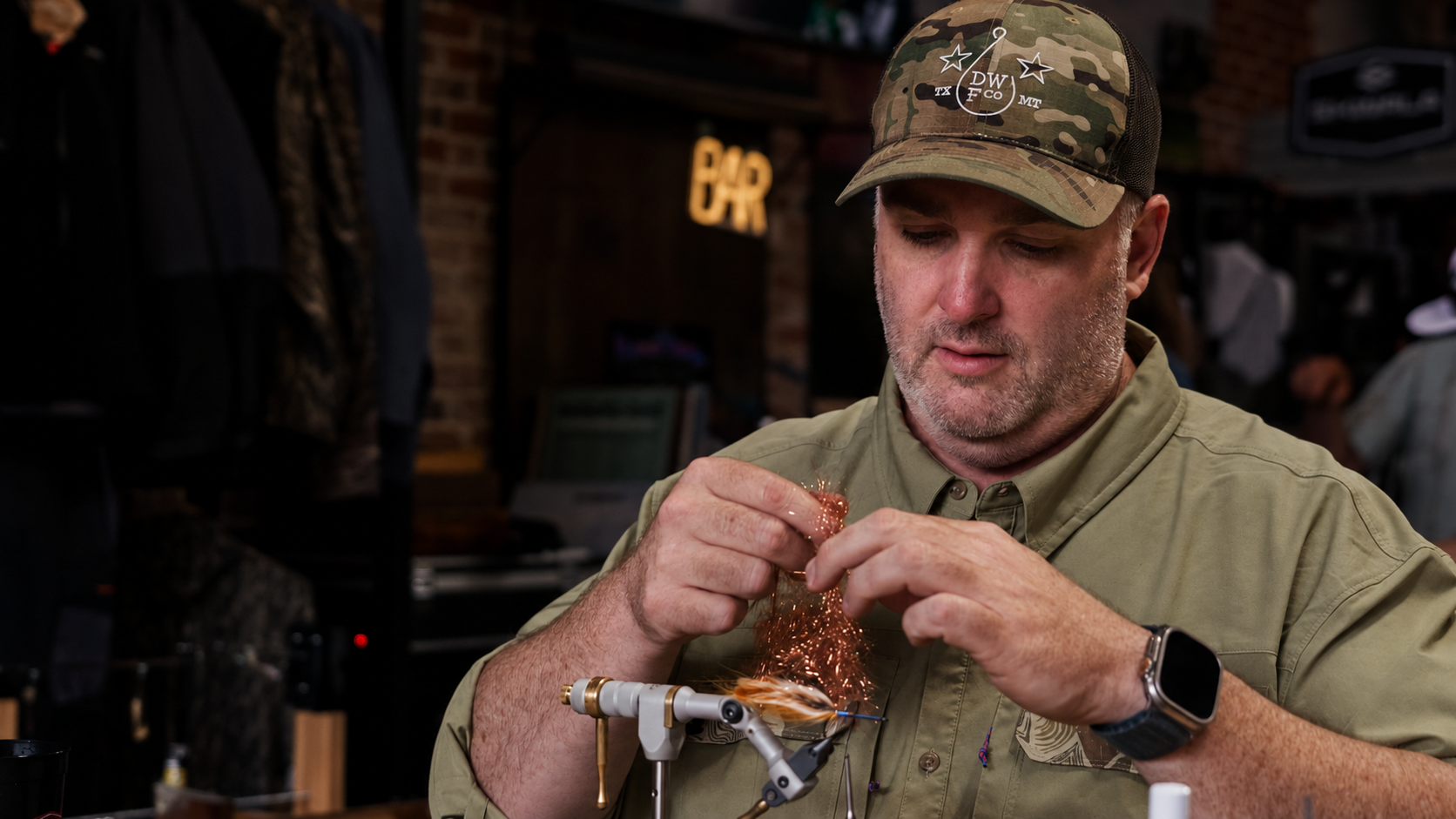 Lee H. Blanton tying a fly at a white vise.