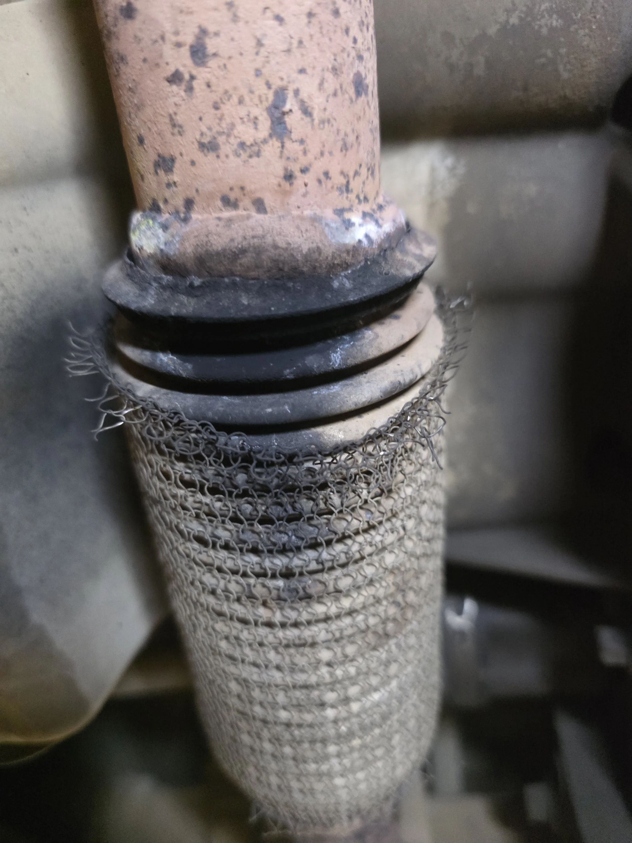A close-up of an exhaust flexi pipe leaked found on an mot pre inspection
