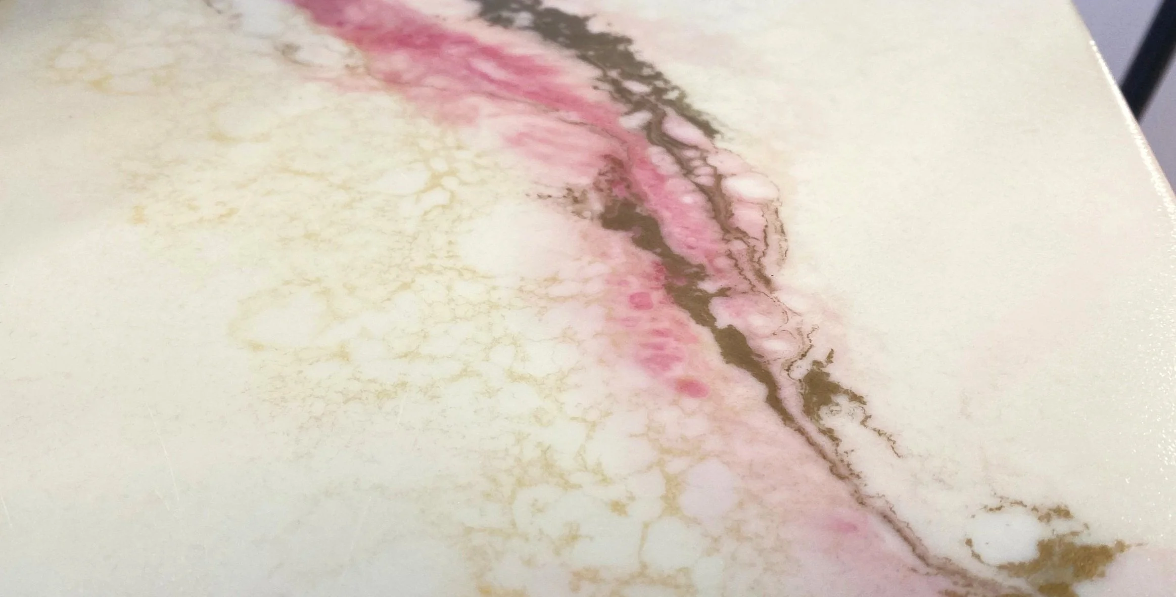 White, pink and gold marble effect resin surface