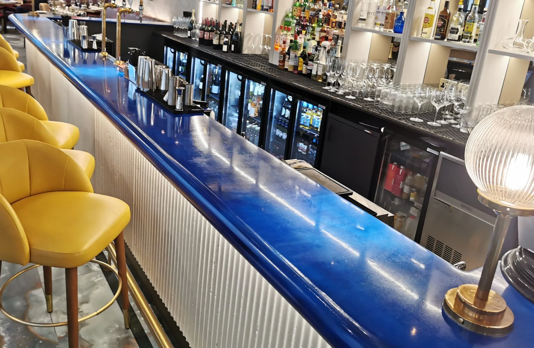 Blue epoxy bartop in busy hotel bar