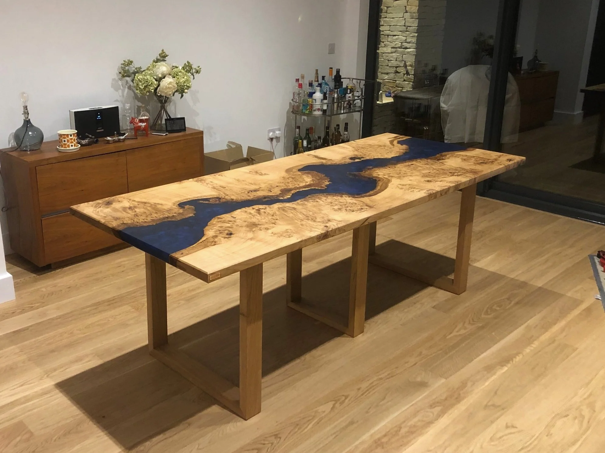 Dark blue epoxy resin and oak river dining table in living room