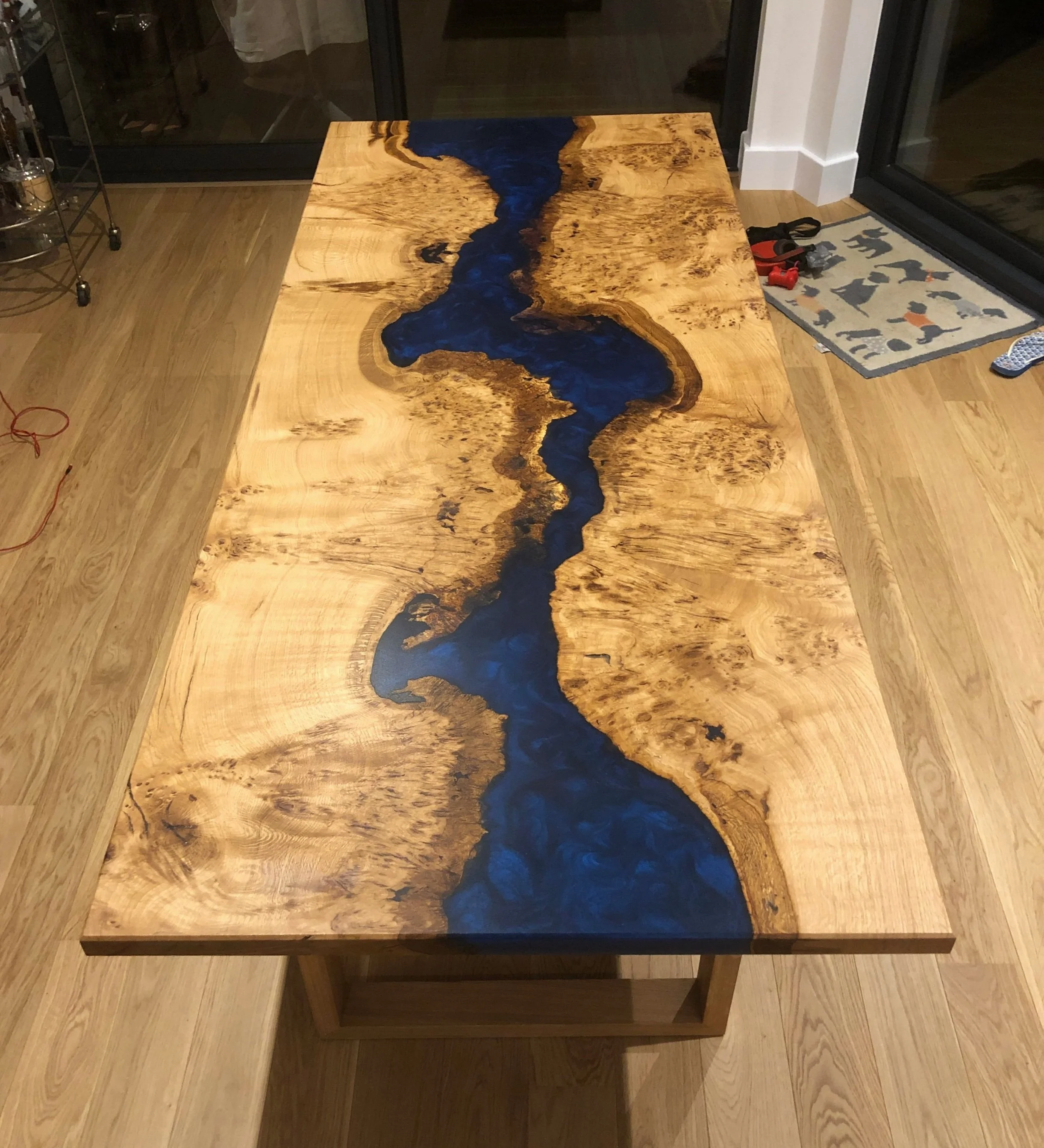 Midnight blue epoxy resin and wood river design dining table end view