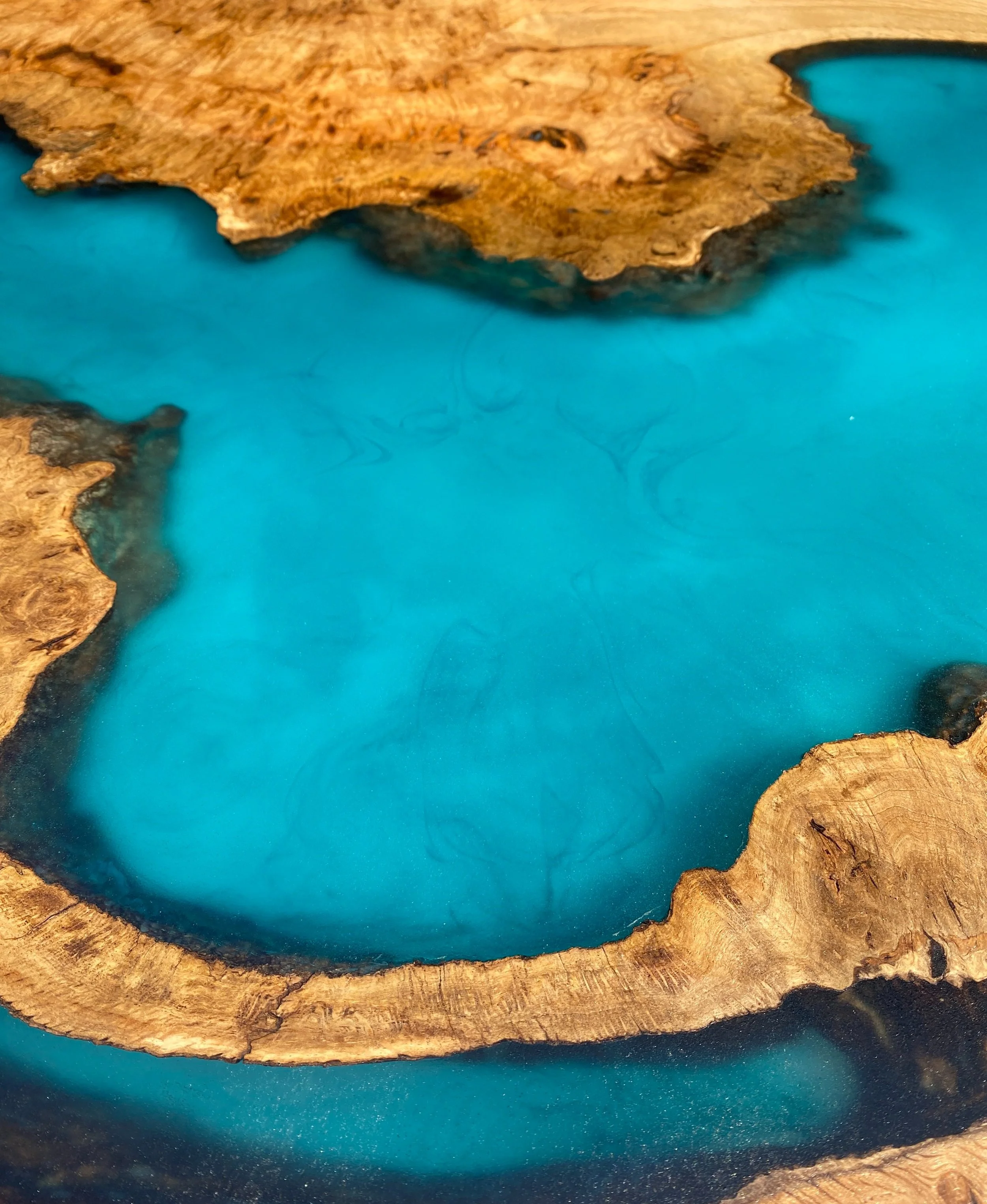 Epoxy resin lagoon in a river table