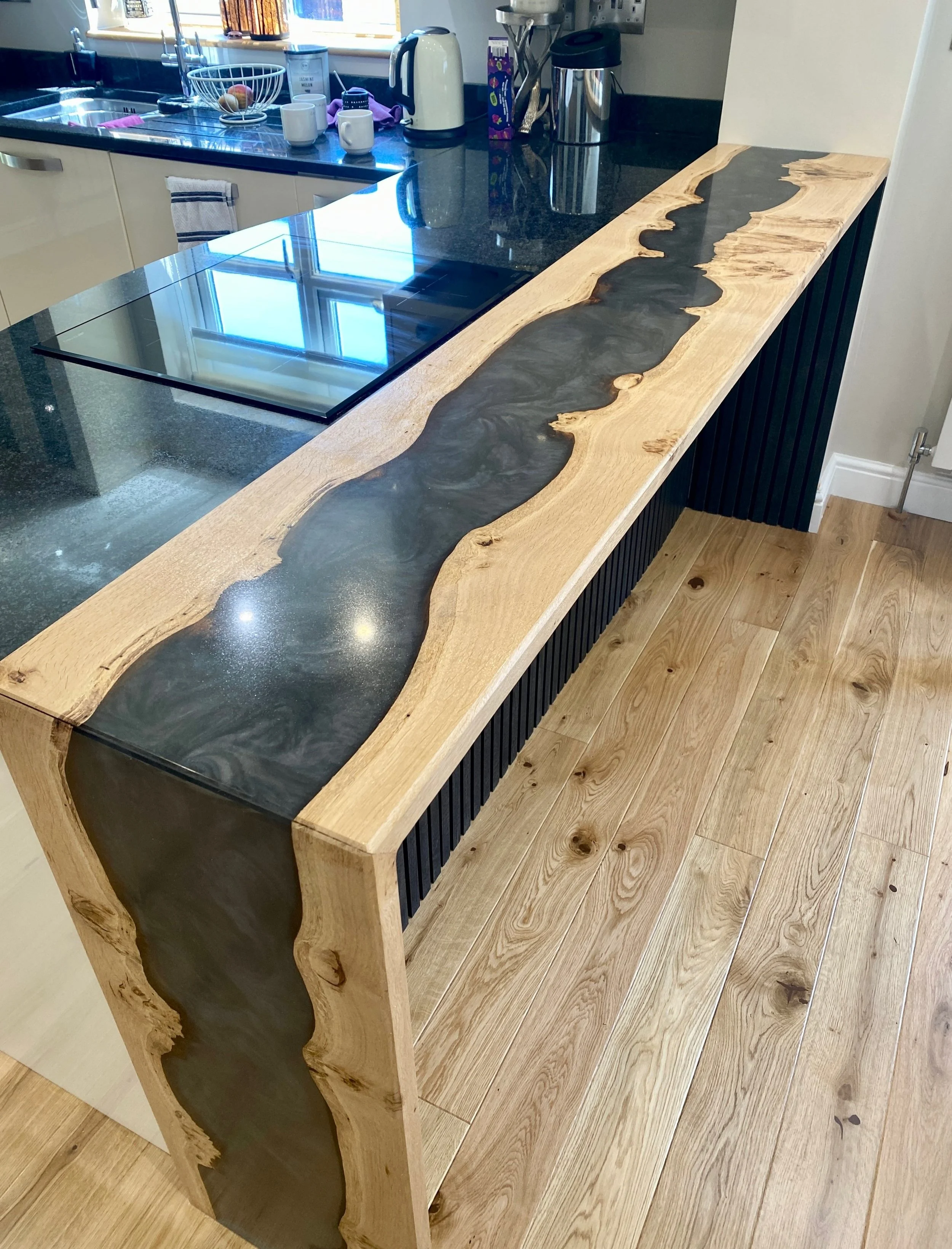 Epoxy resin river breakfast bar with waterfall leg in black and silver