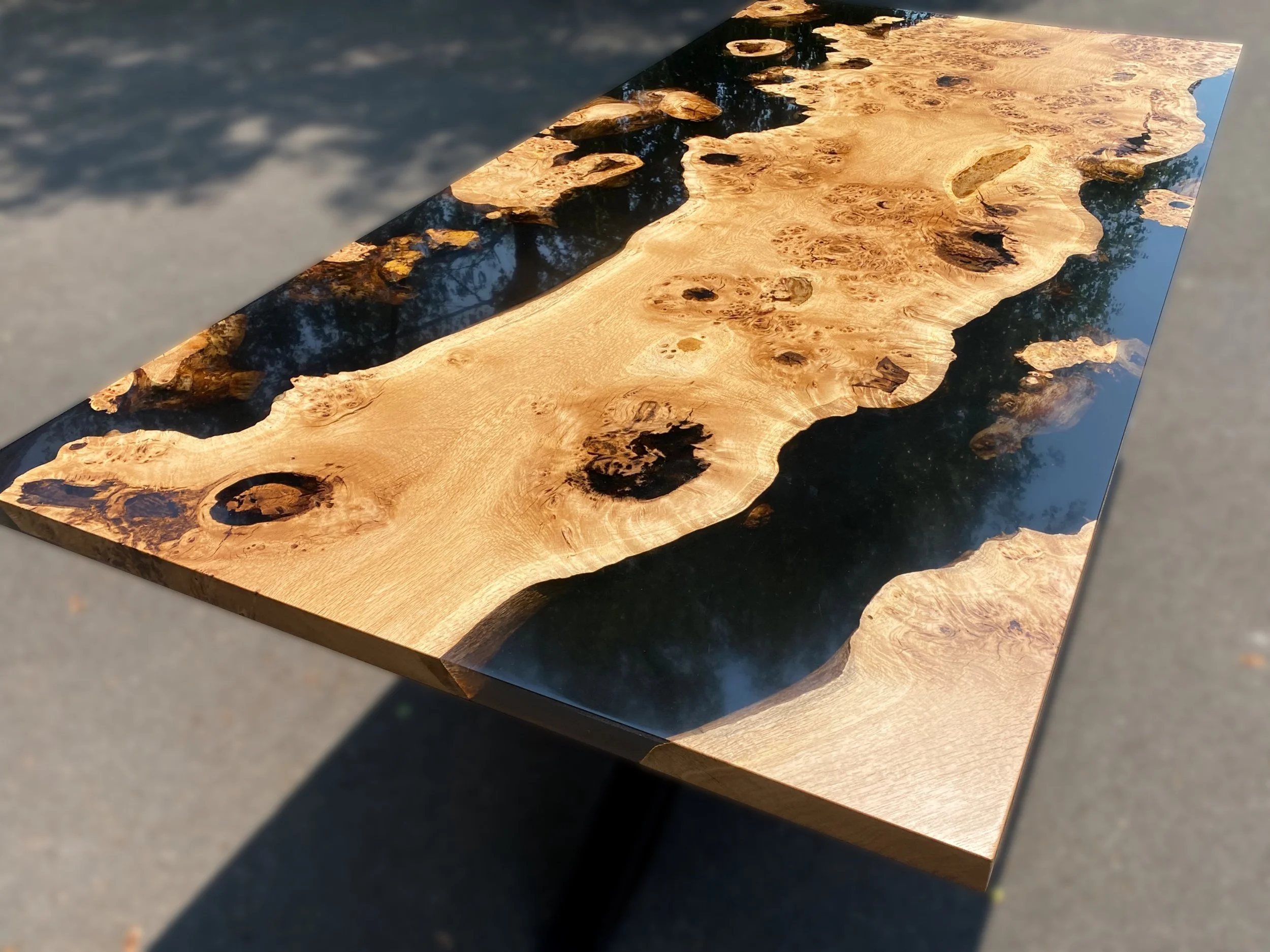 Black epoxy resin and oak dining table photo taken on angle