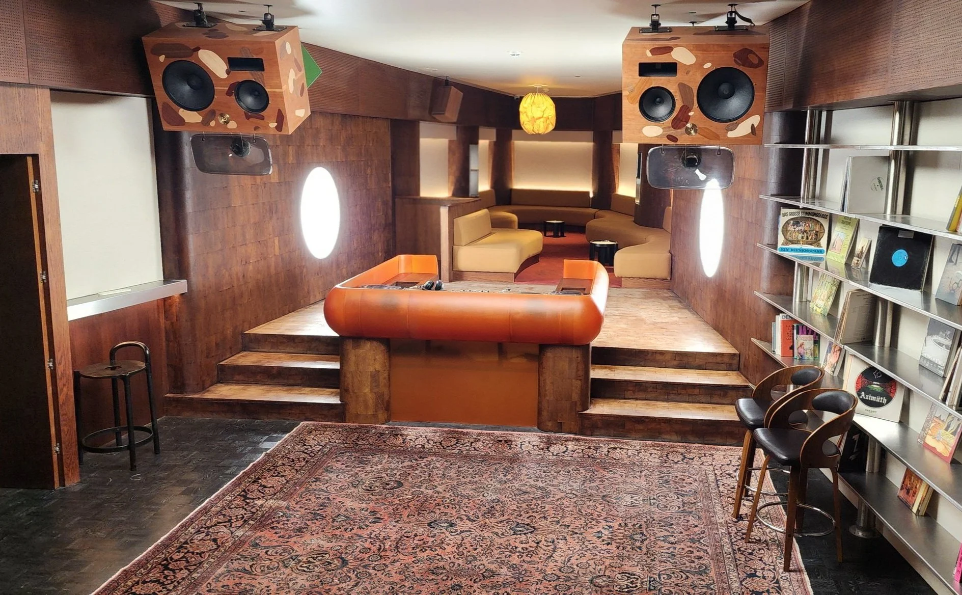 Epoxy resin DJ Booth, orange resin and dark wood in listening bar.