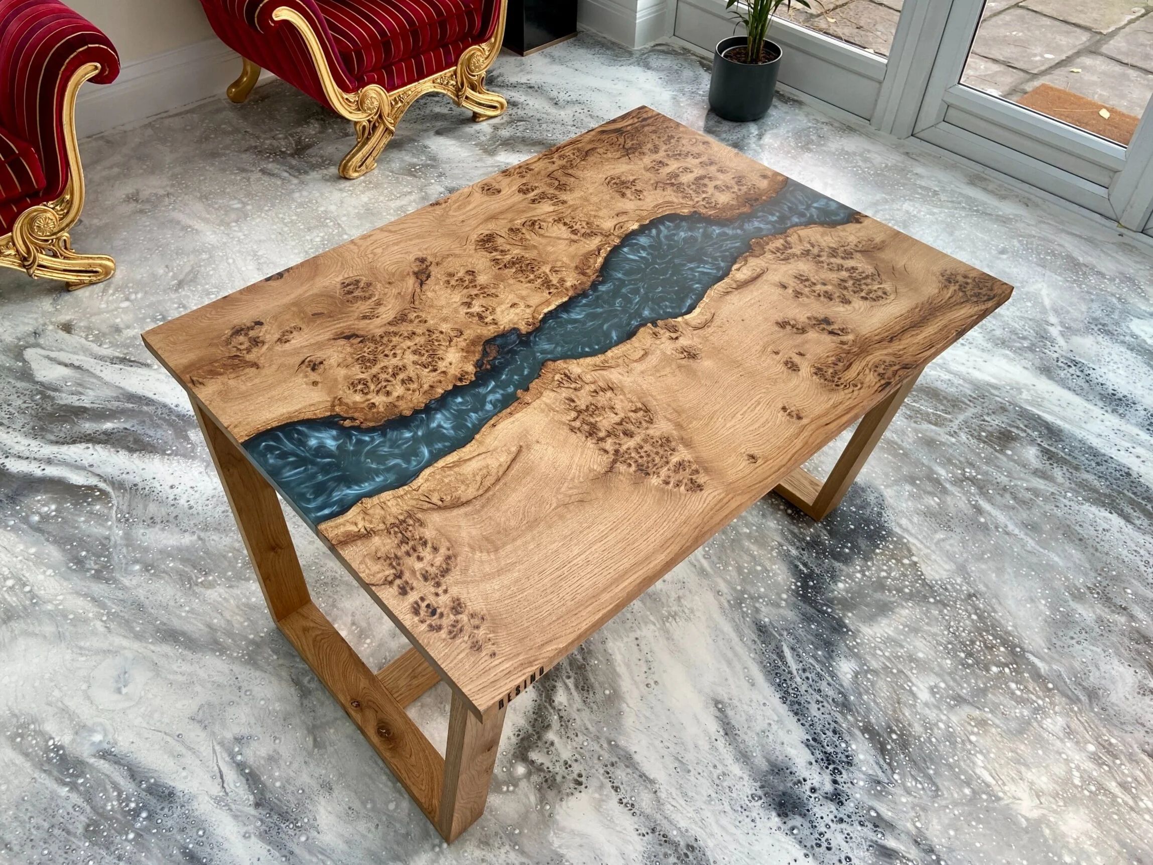 river effect dining table on an angle with chairs in background