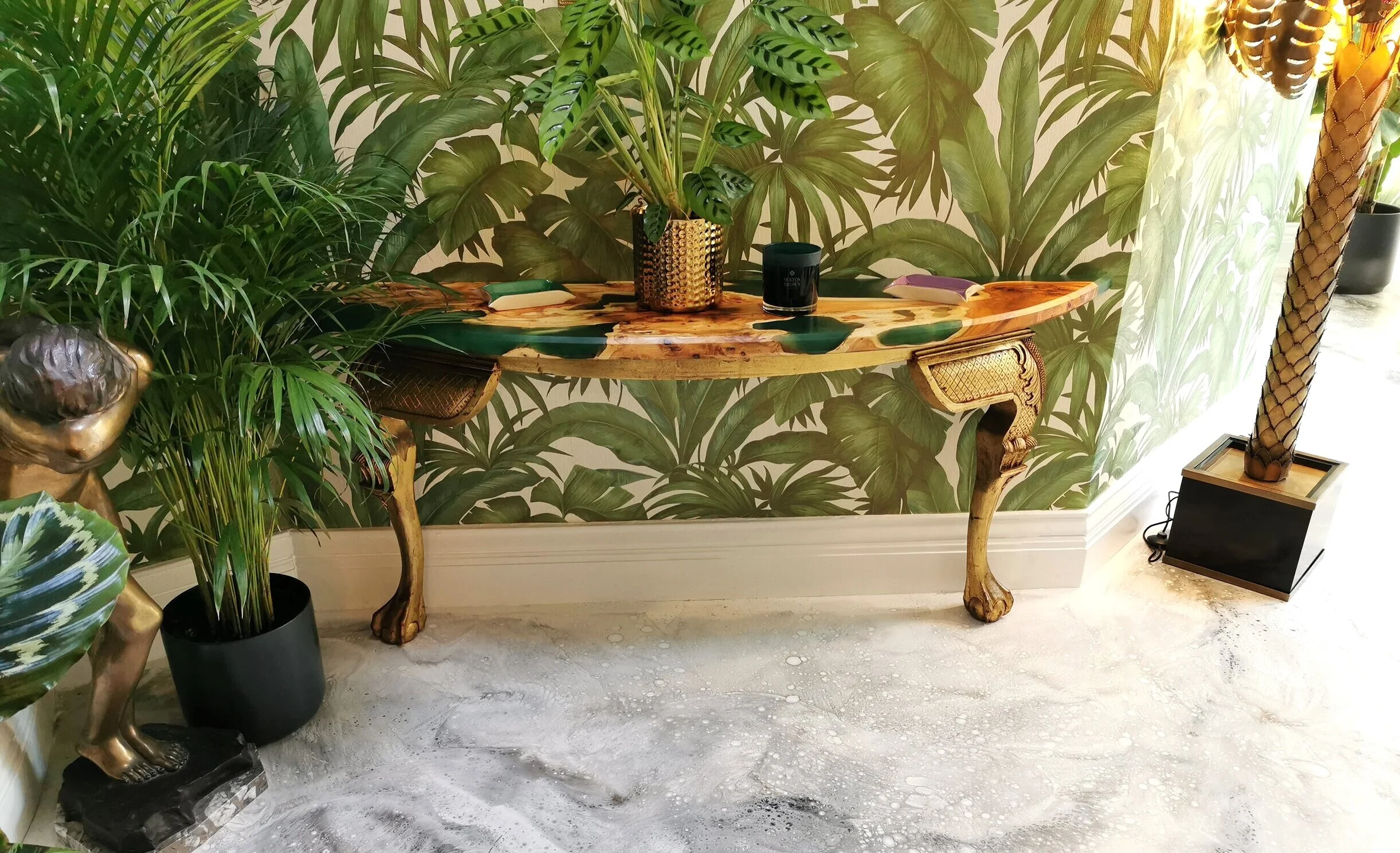 Epoxy resin console table front view with leafy/jungle wall paper