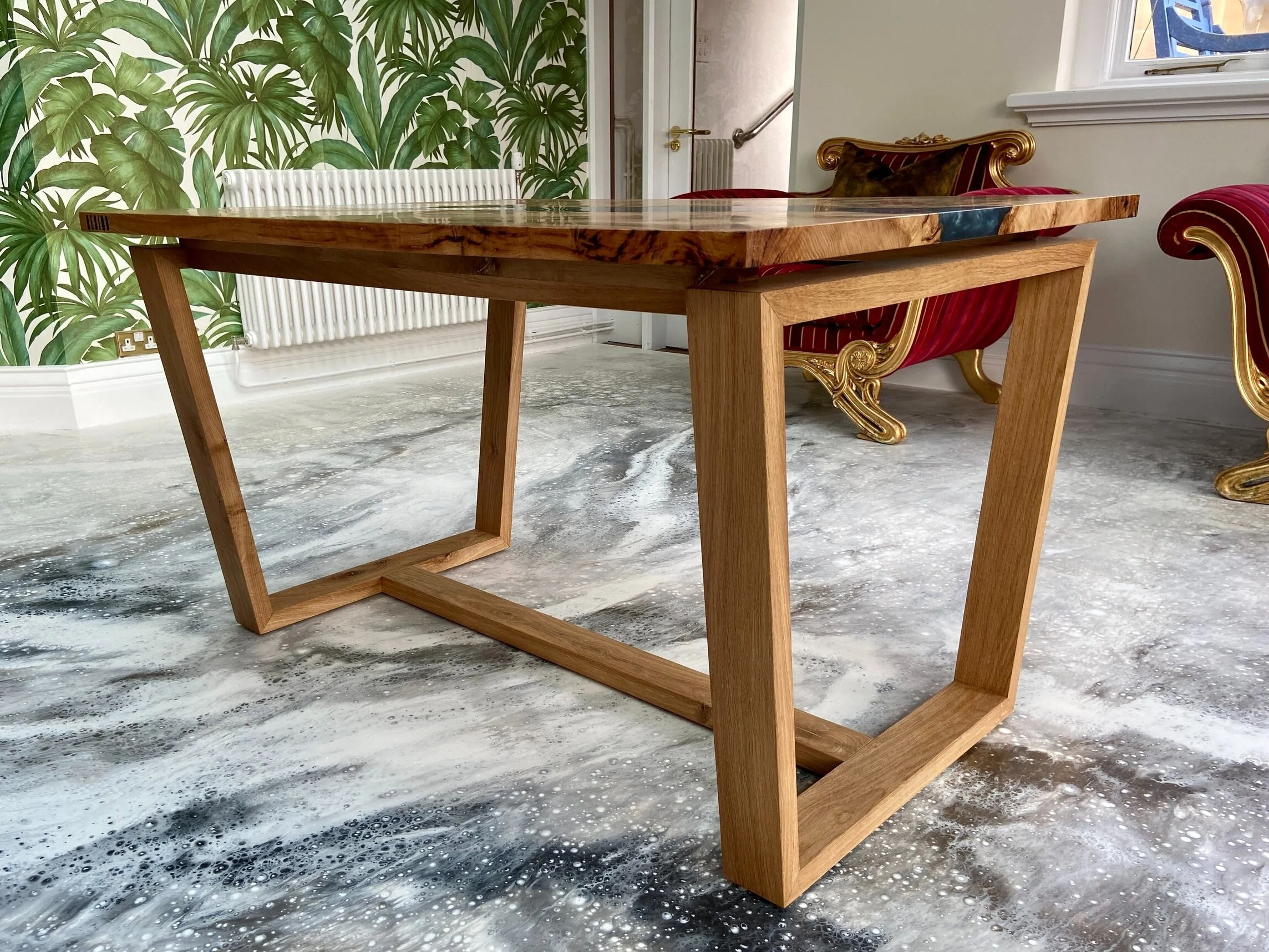 floating top dining table on angle and white marble effect resin floor