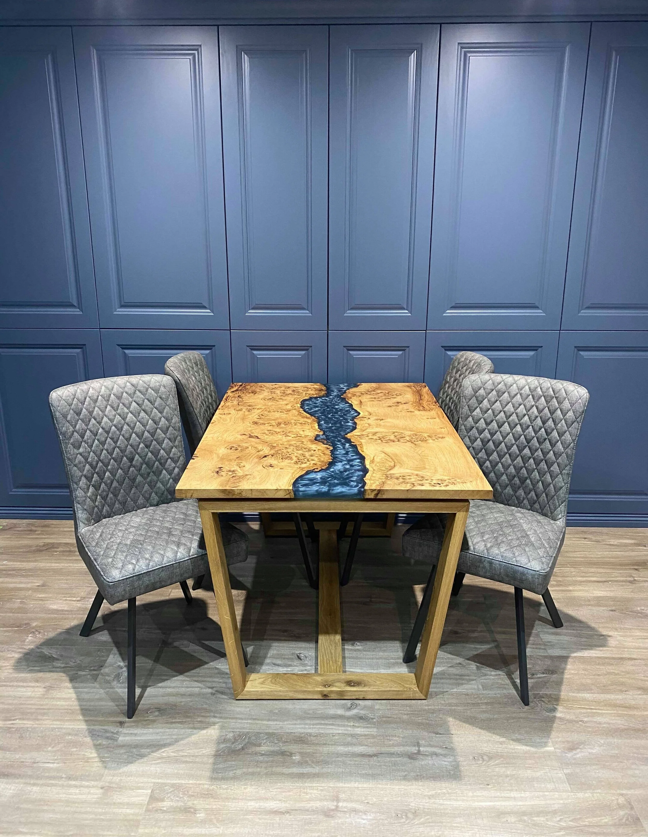 dining table with chairs and blue cupboards in background