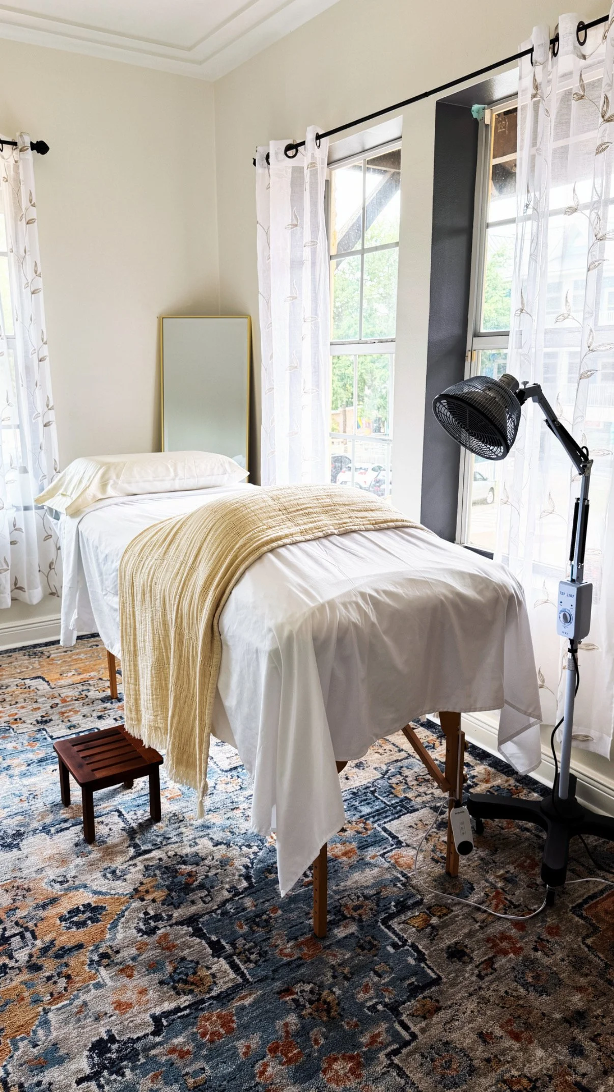 Quiet treatment room at The Acupuncture Portal in Gulfport, Florida, with a made treatment table by the window