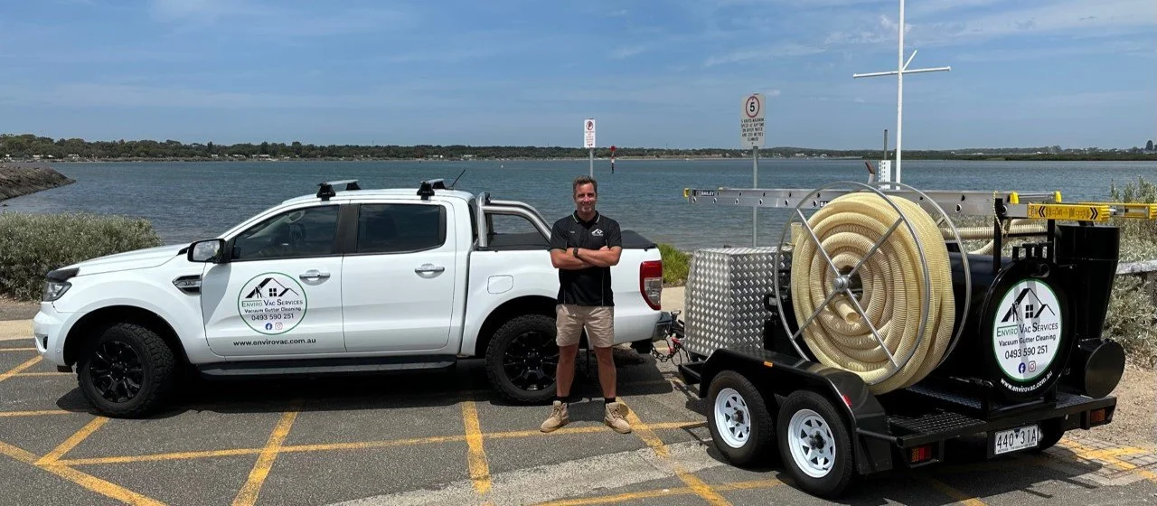 Owner and operator of Enviro Vac Outdoor Services standing with the mobile fully self contained industrial vacuum equipment