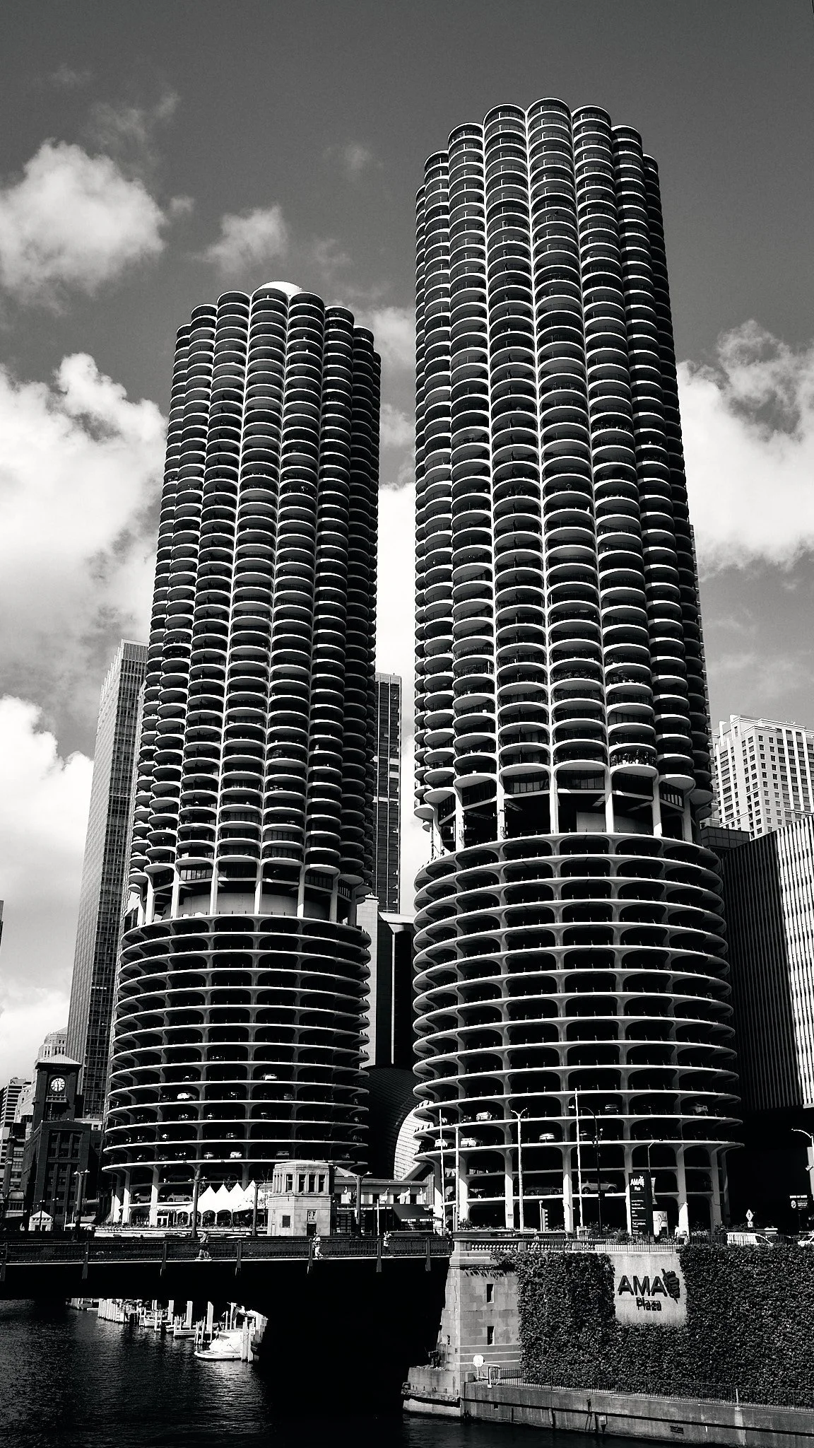 Black and white photograph of the Marina City Towers, two cylindrical high-rise buildings with rounded balconies, in Chicago.