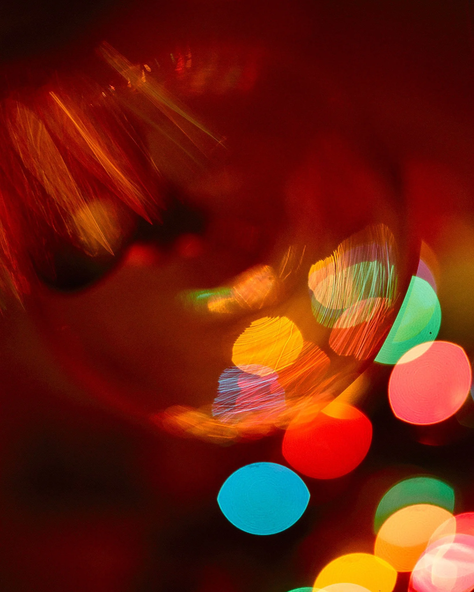 Blurred colorful lights creating an abstract pattern with red, yellow, green, blue, and pink hues.
