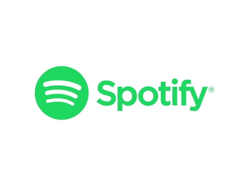 Spotify logo with green circle and three curved lines next to the green text 'Spotify' on a white background.
