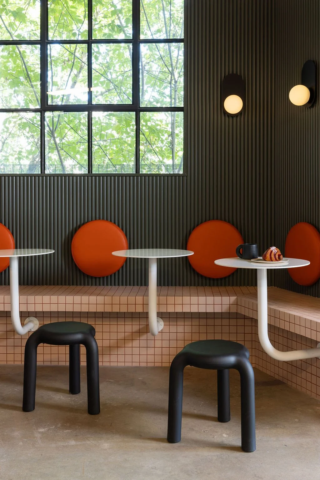 Custom café seating and colourful millwork designed by Flodström Interiors