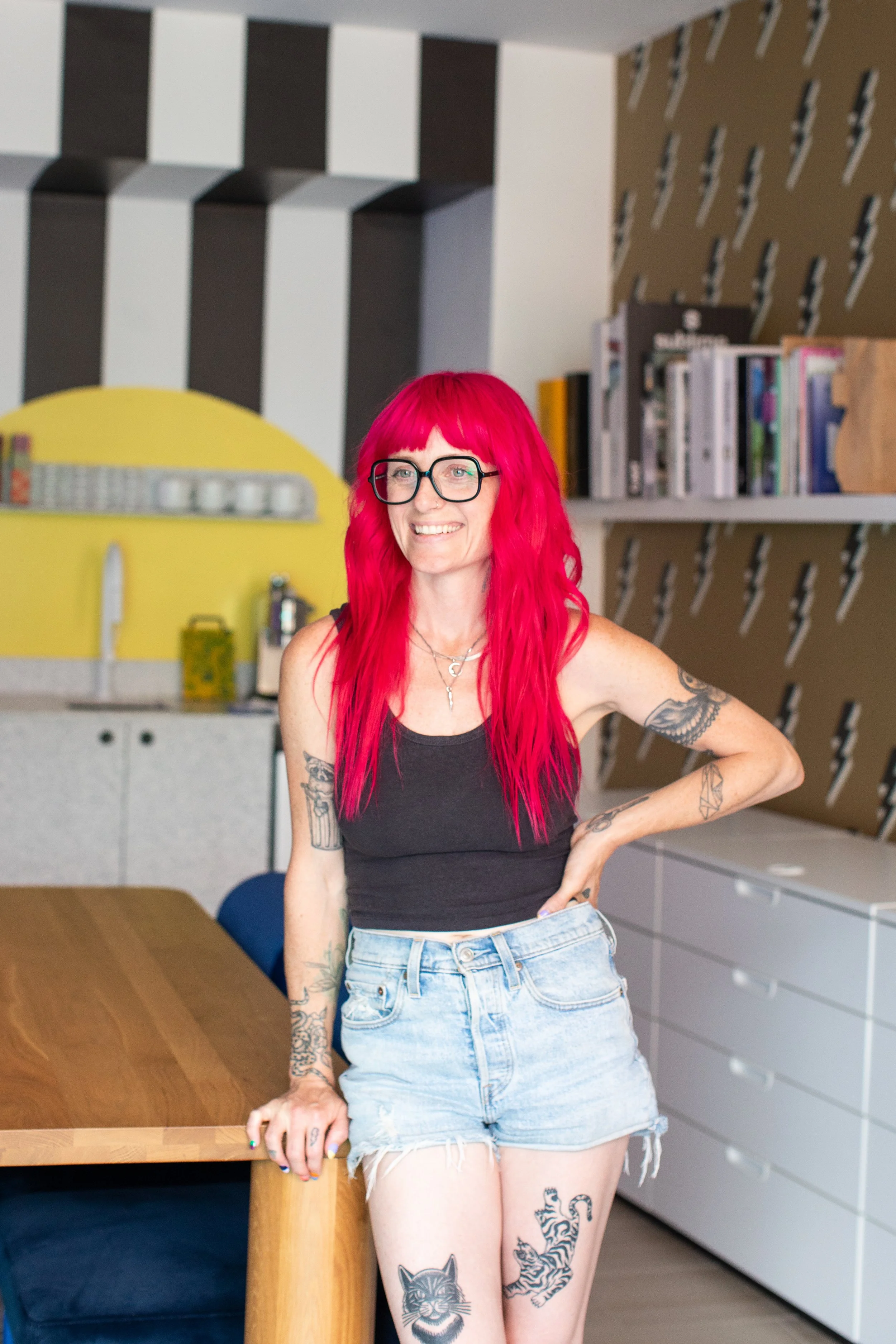 Interior designer Shanna Flodström, founder of Flodström Interiors, photographed in her Toronto design studio with bold black-and-white stripes, a yellow kitchen backsplash and custom furnishings.