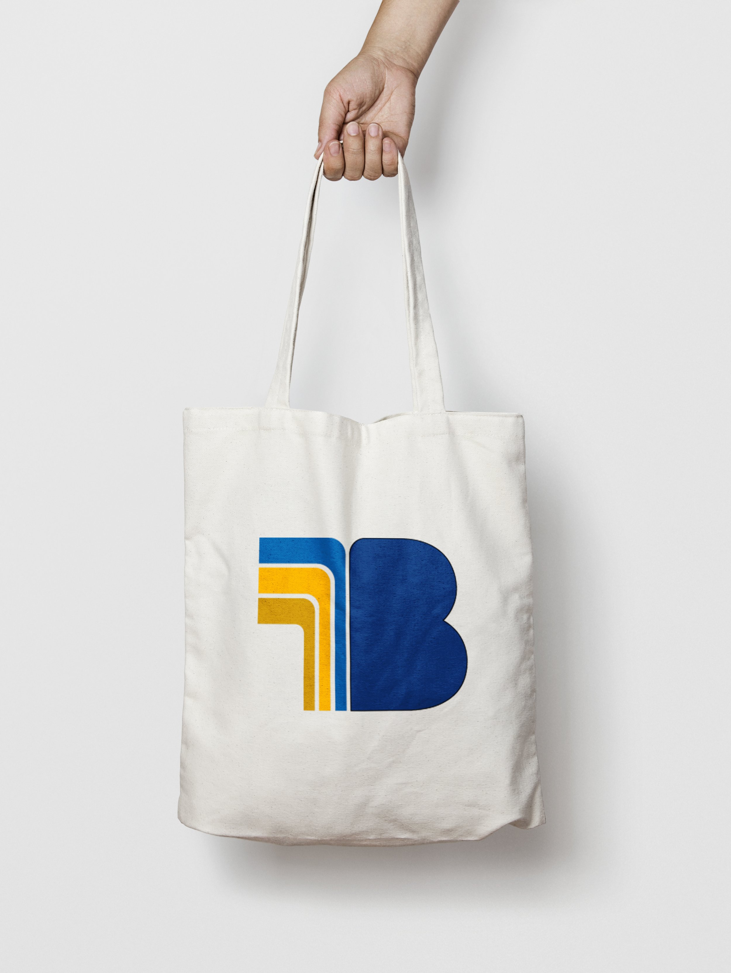 White canvas tote bag mockup featuring the blue and orange Belltone brand symbol.