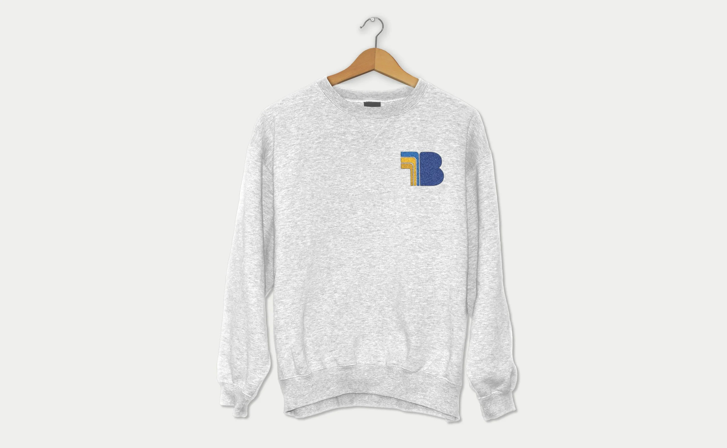 Grey sweatshirt mockup with the Belltone geometric brand symbol printed on the chest.