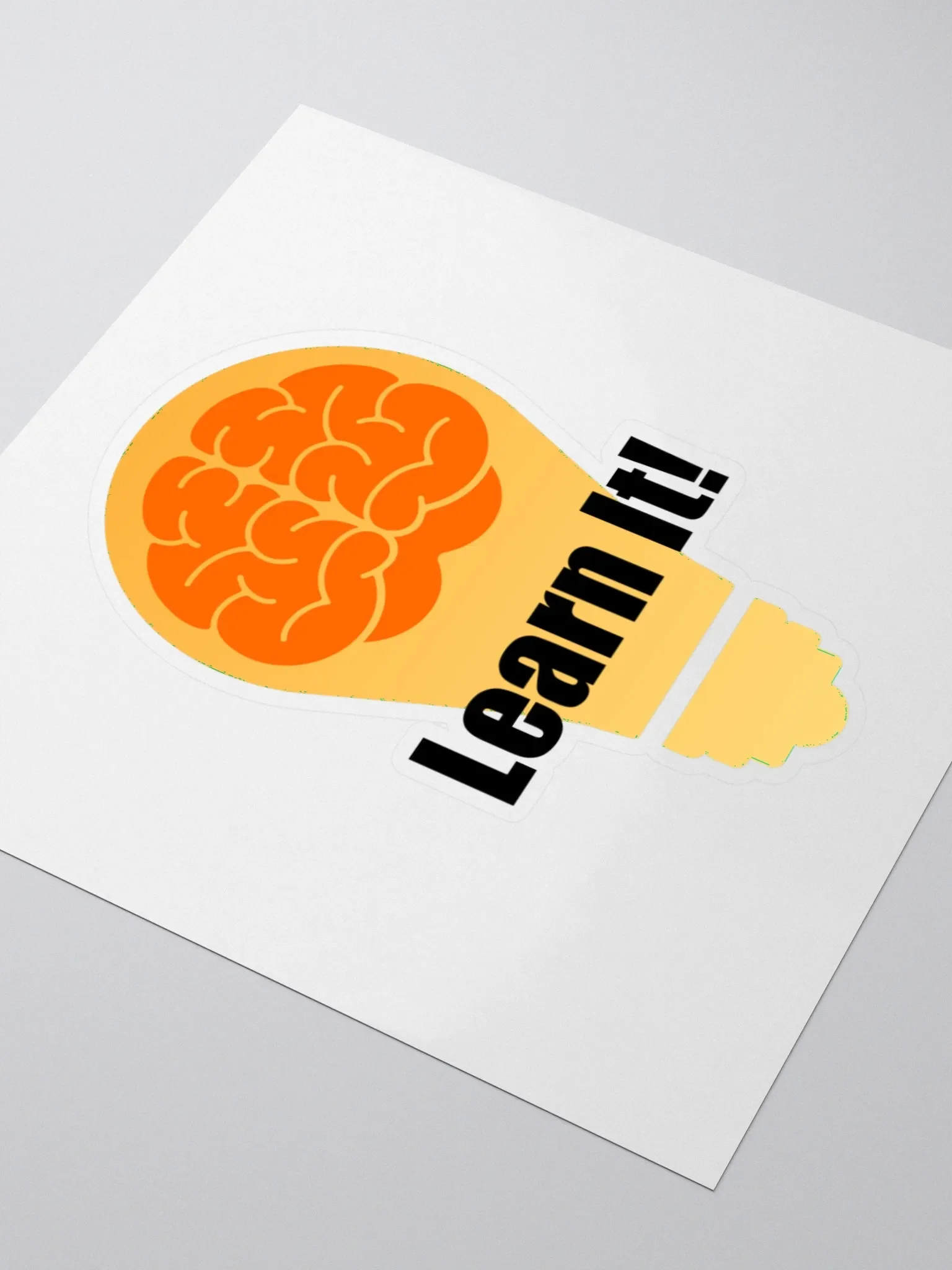 Sticker of a brain with the word 'LOGIC' partially visible on a white surface.