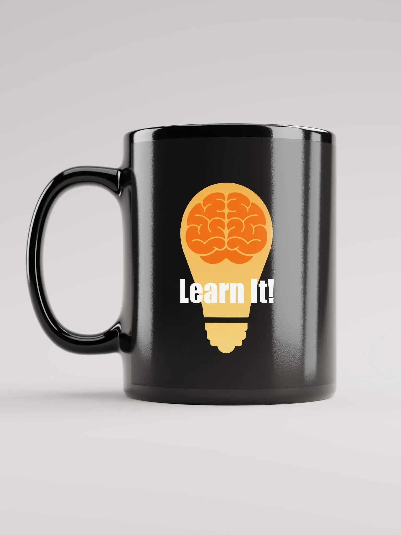Black Learn It! coffee mug featuring the orange brain-and-lightbulb logo.