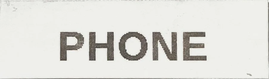Close-up of label text that reads 'PHONE' on a white background.