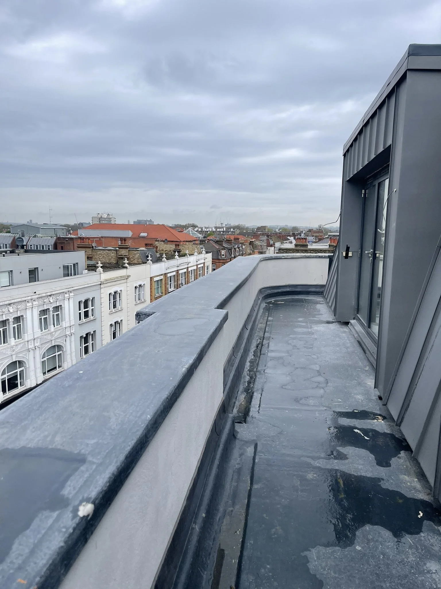 Rooftop view of historic urban buildings under an overcast sky