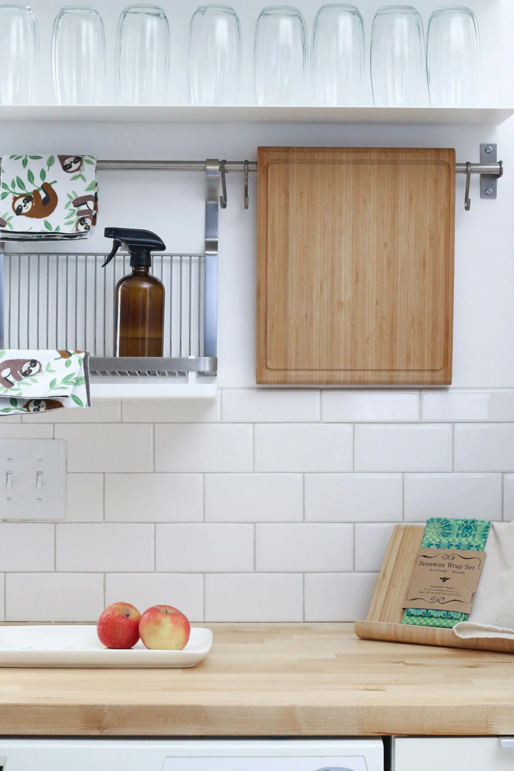 Bright, clean kitchen with white tile and a wooden countertop