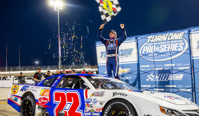 Kyle Steckly Race car driver celebrates on top of a No. 22 stock car after a Turn One Racing Owosso Series victory