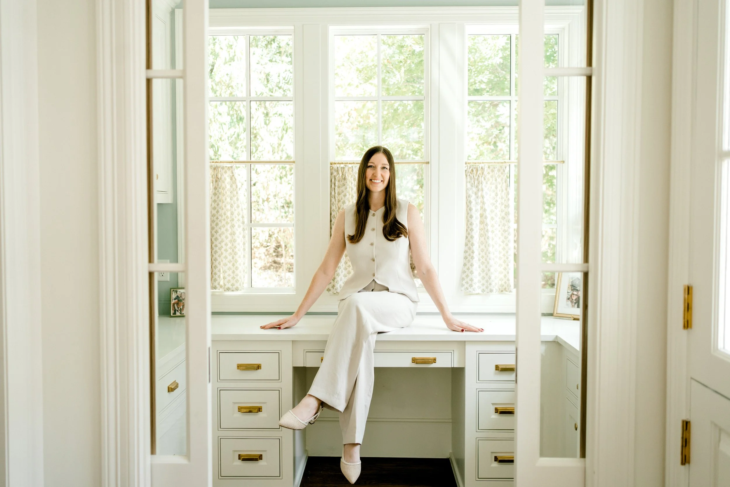 Amanda Polton, founder of OrganizePro and former occupational therapist, seated in a bright, beautifully organized home office.